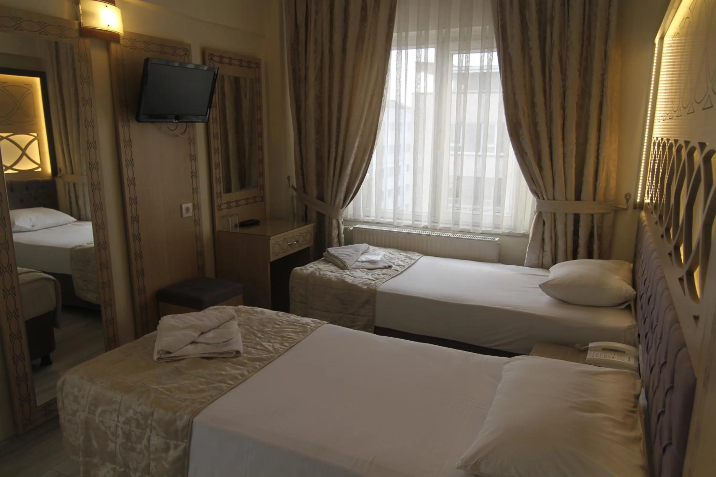 Bed in Grand Liza Hotel
