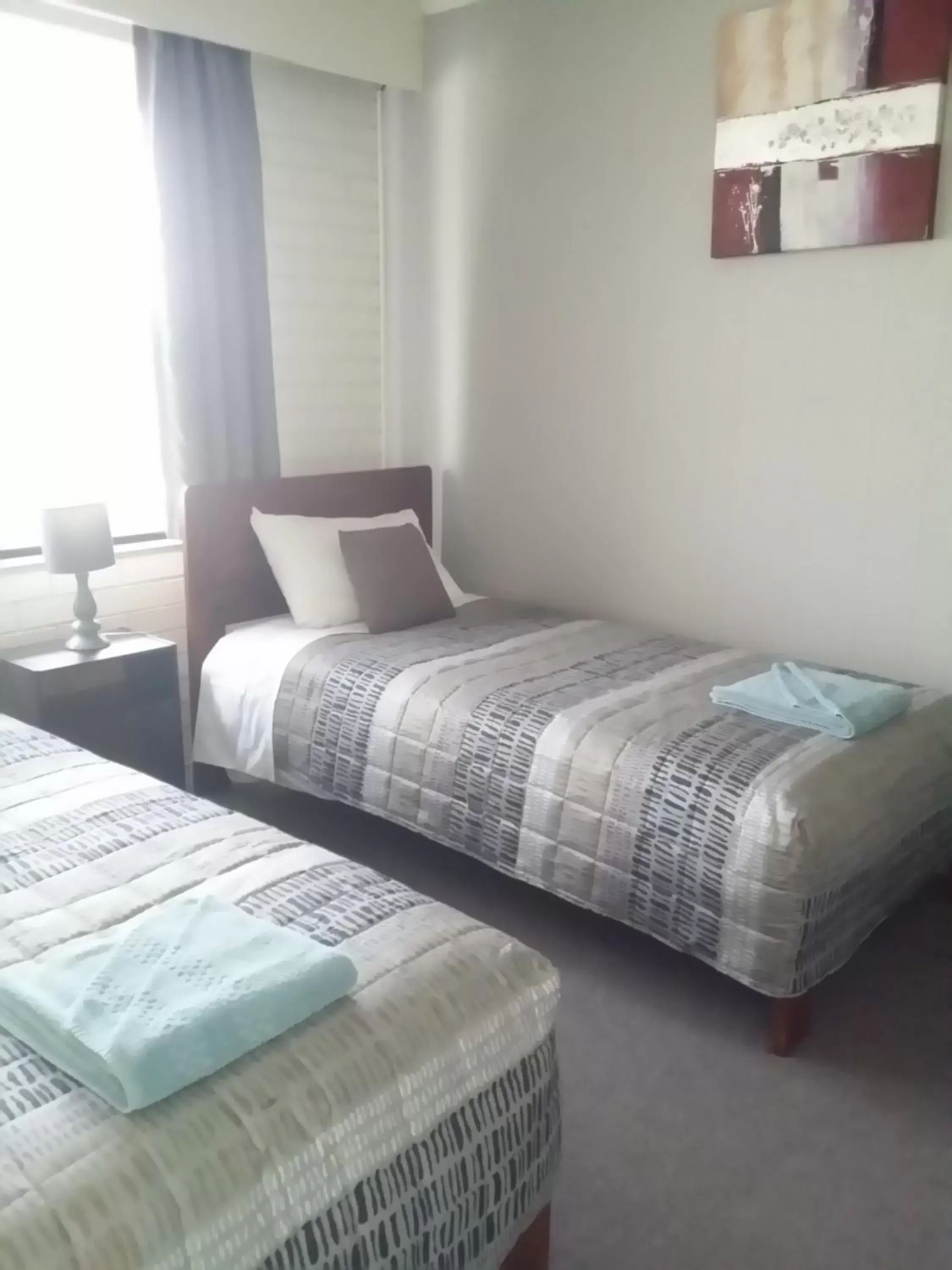 Bed in White Manor Motel