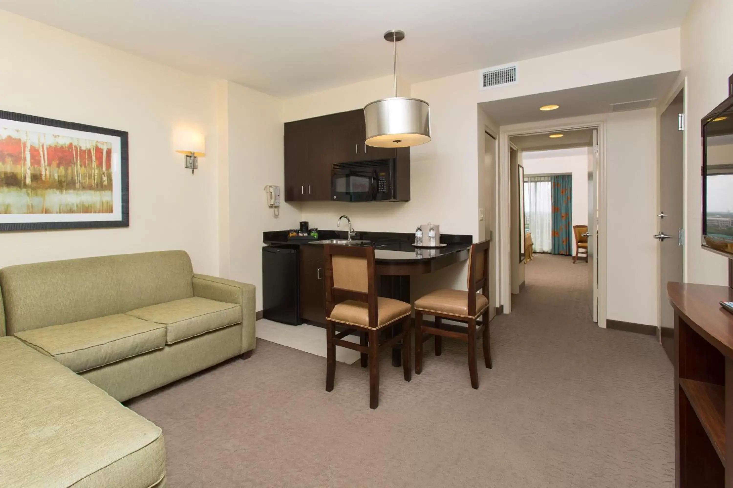 Living room, Seating Area in Ramada Suites By Wyndham Orlando International Drive