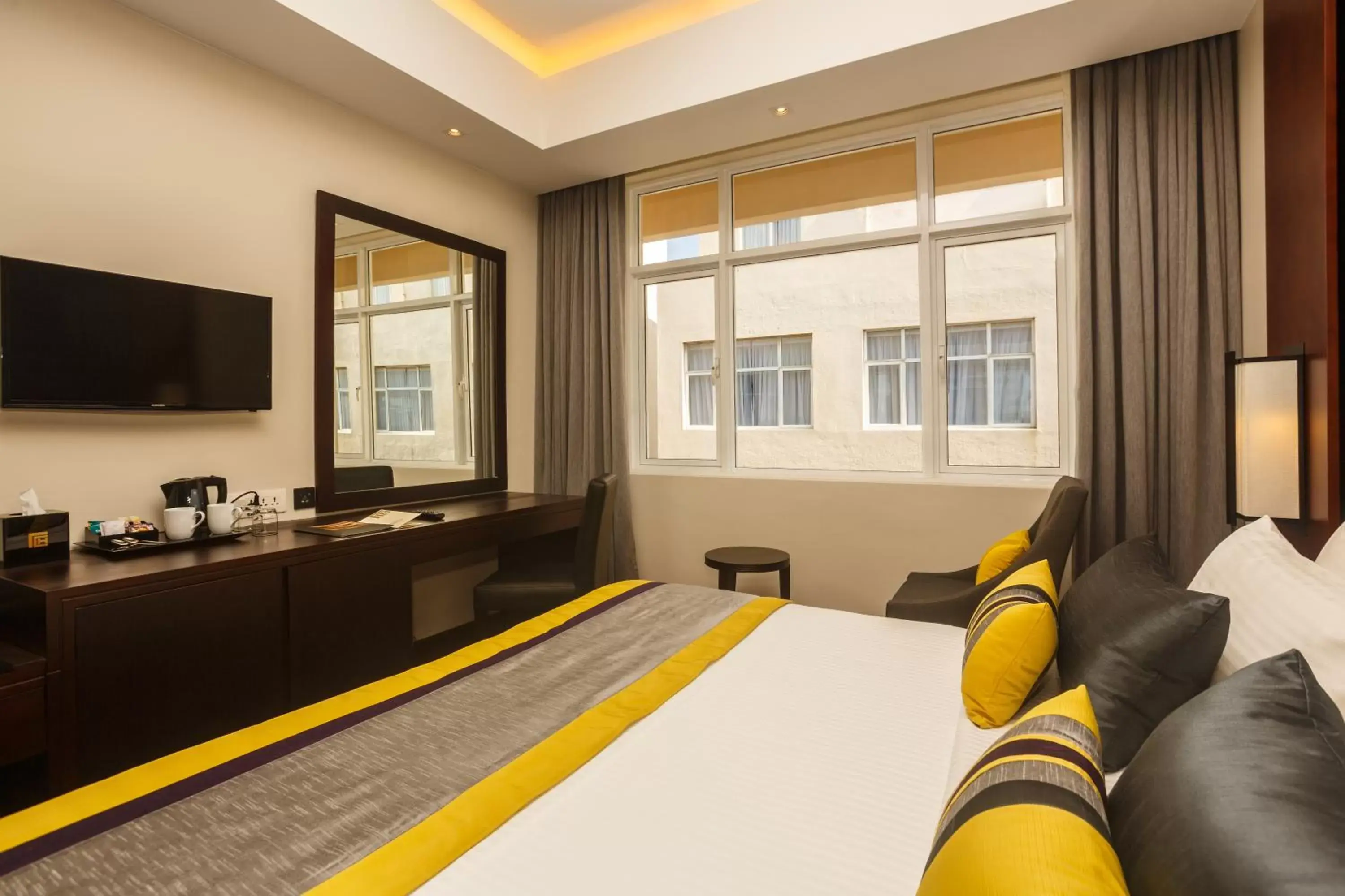 Bedroom, TV/Entertainment Center in Renuka City Hotel