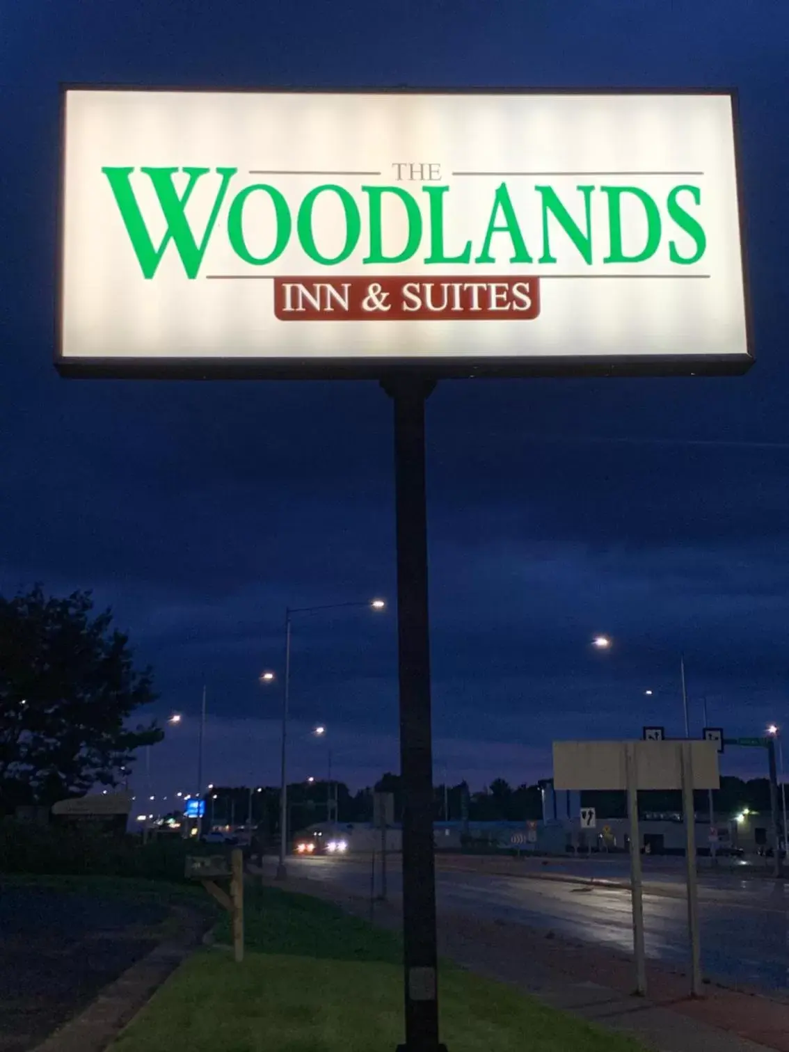 Property logo or sign in Woodland Inn & Suites