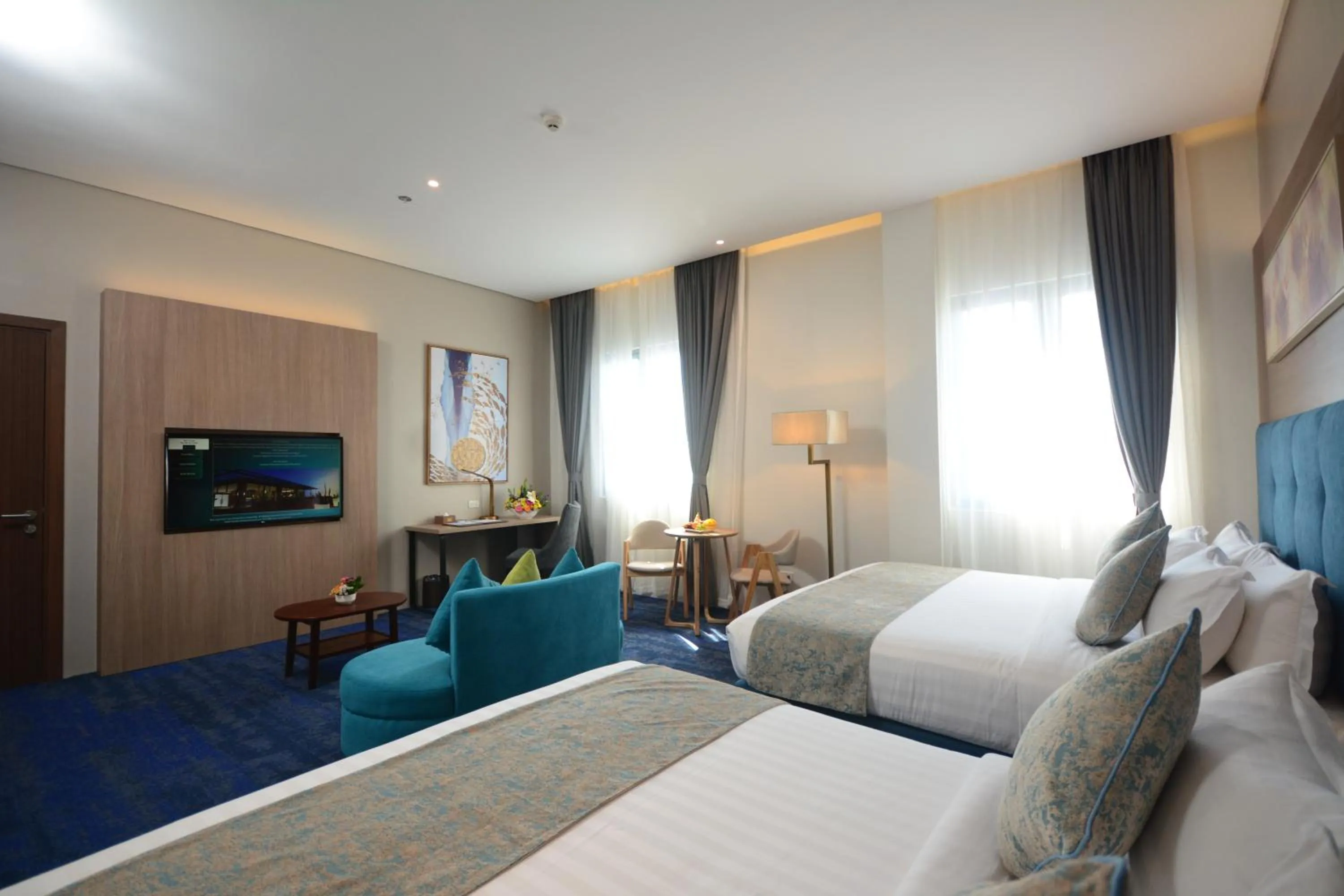 Communal lounge/ TV room, Bed in Blue Lotus Hotel