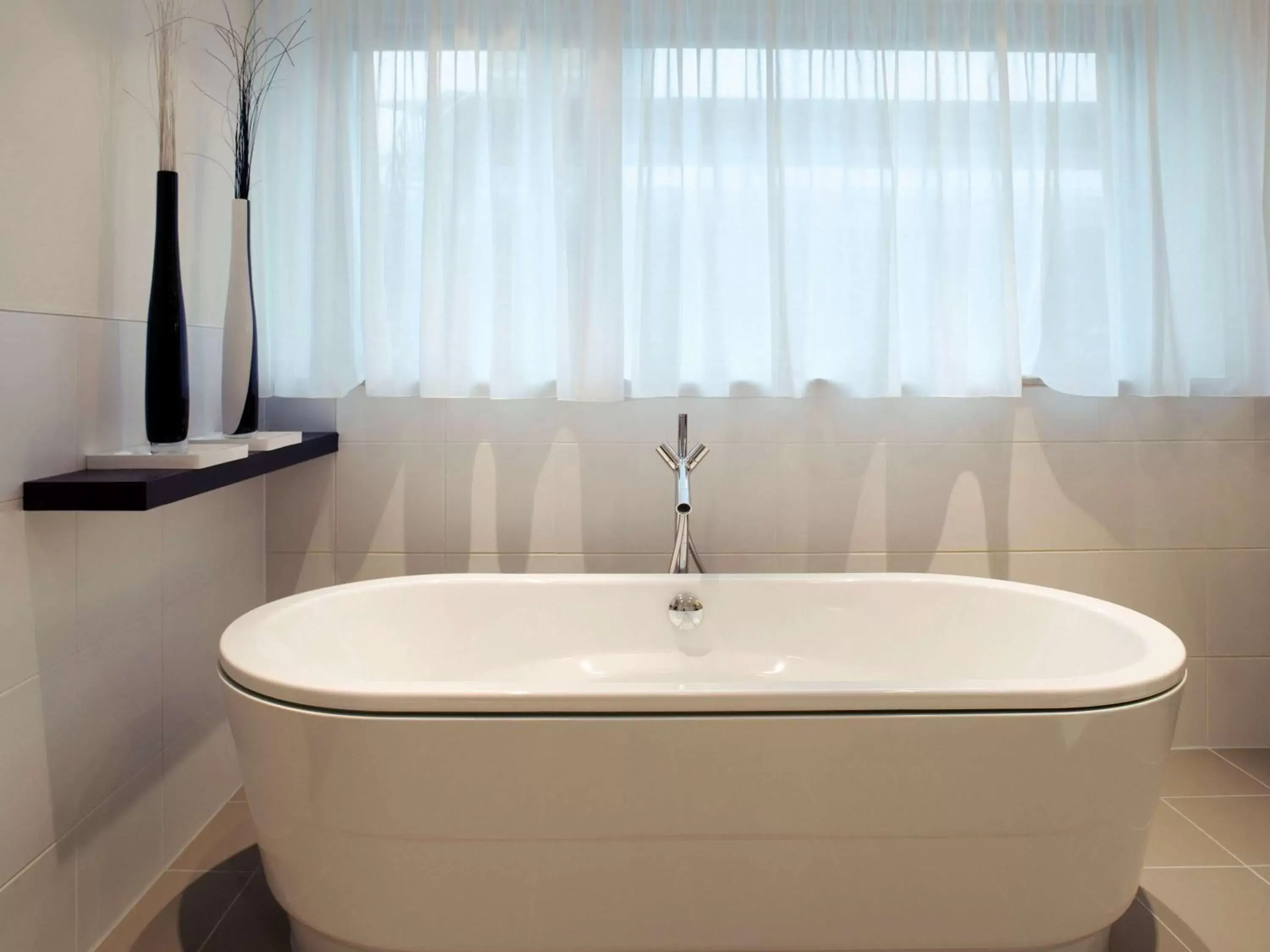 Photo of the whole room, Bathroom in Mövenpick Hotel Amsterdam City Centre