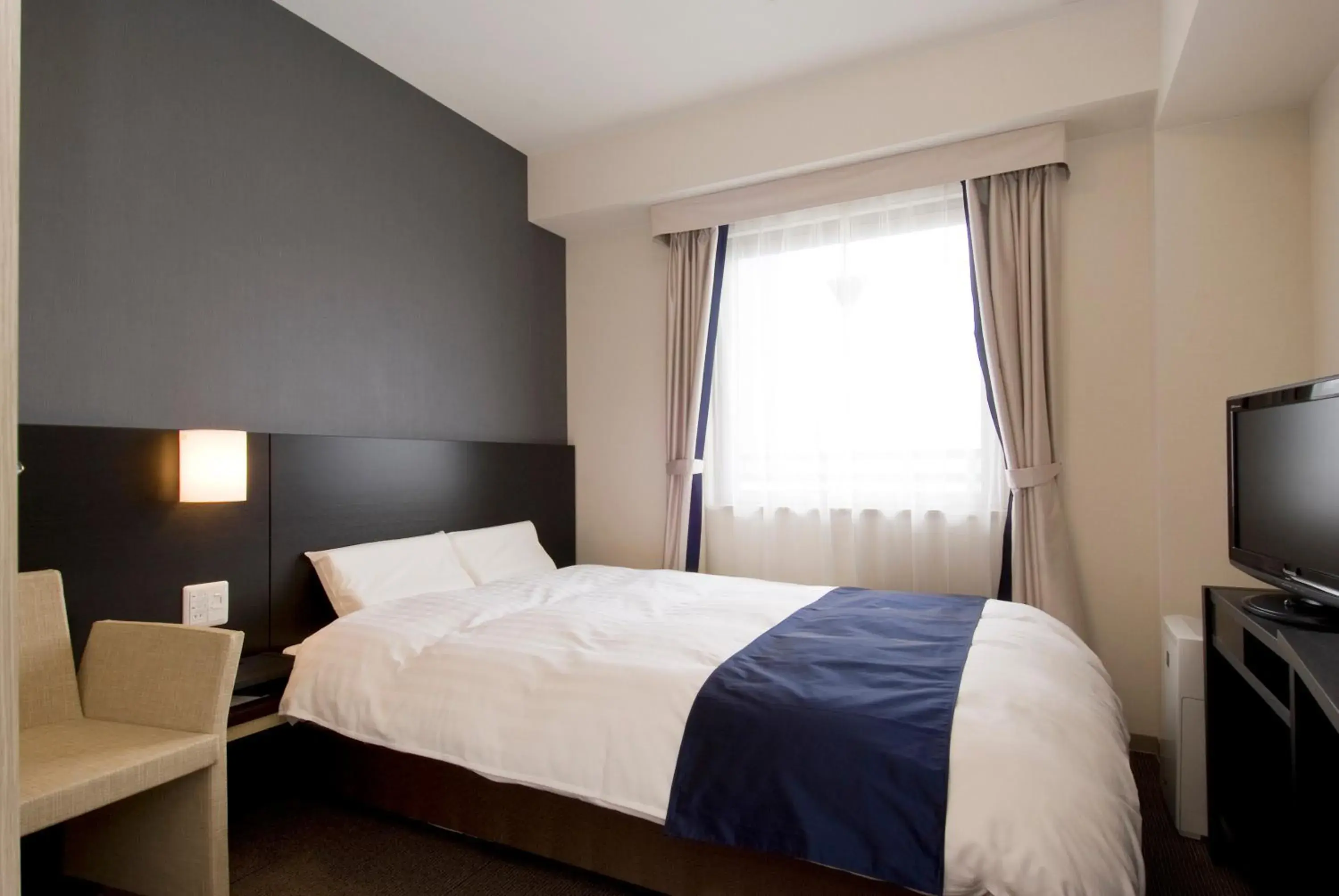 Bed in Dormy Inn Premium Shimonoseki