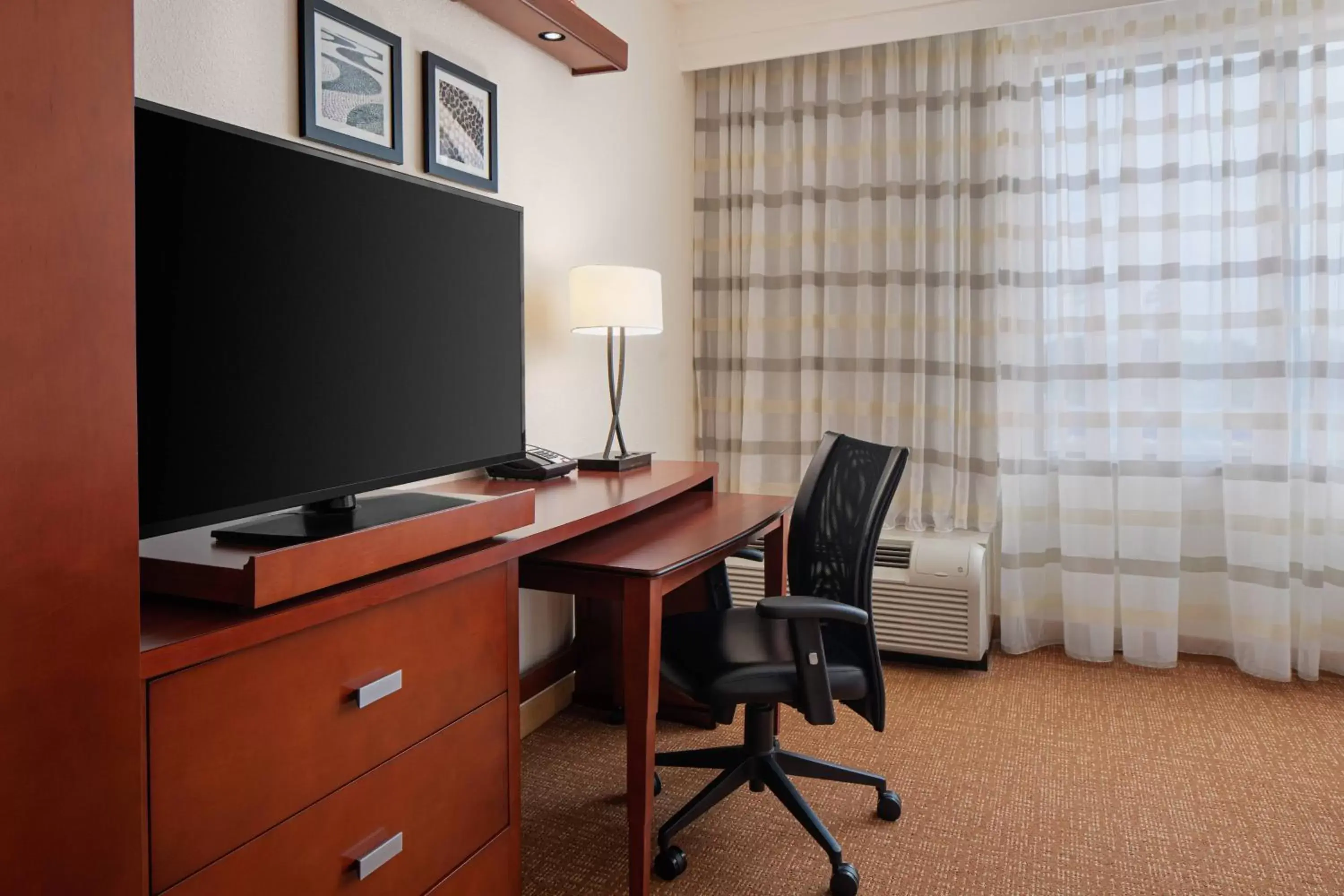 Photo of the whole room, TV/Entertainment Center in Courtyard By Marriott Houston Kingwood