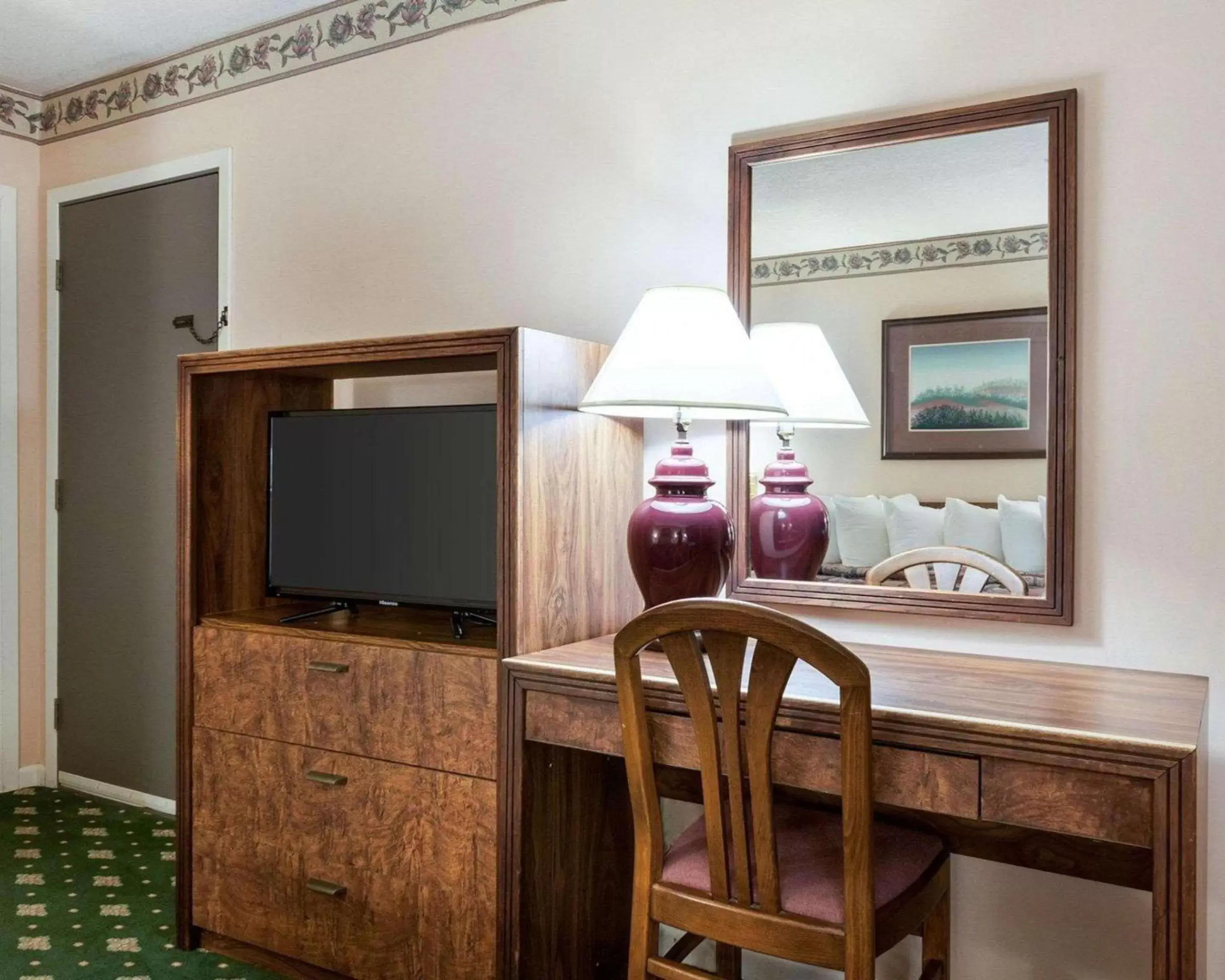 Photo of the whole room, TV/Entertainment Center in Rodeway Inn