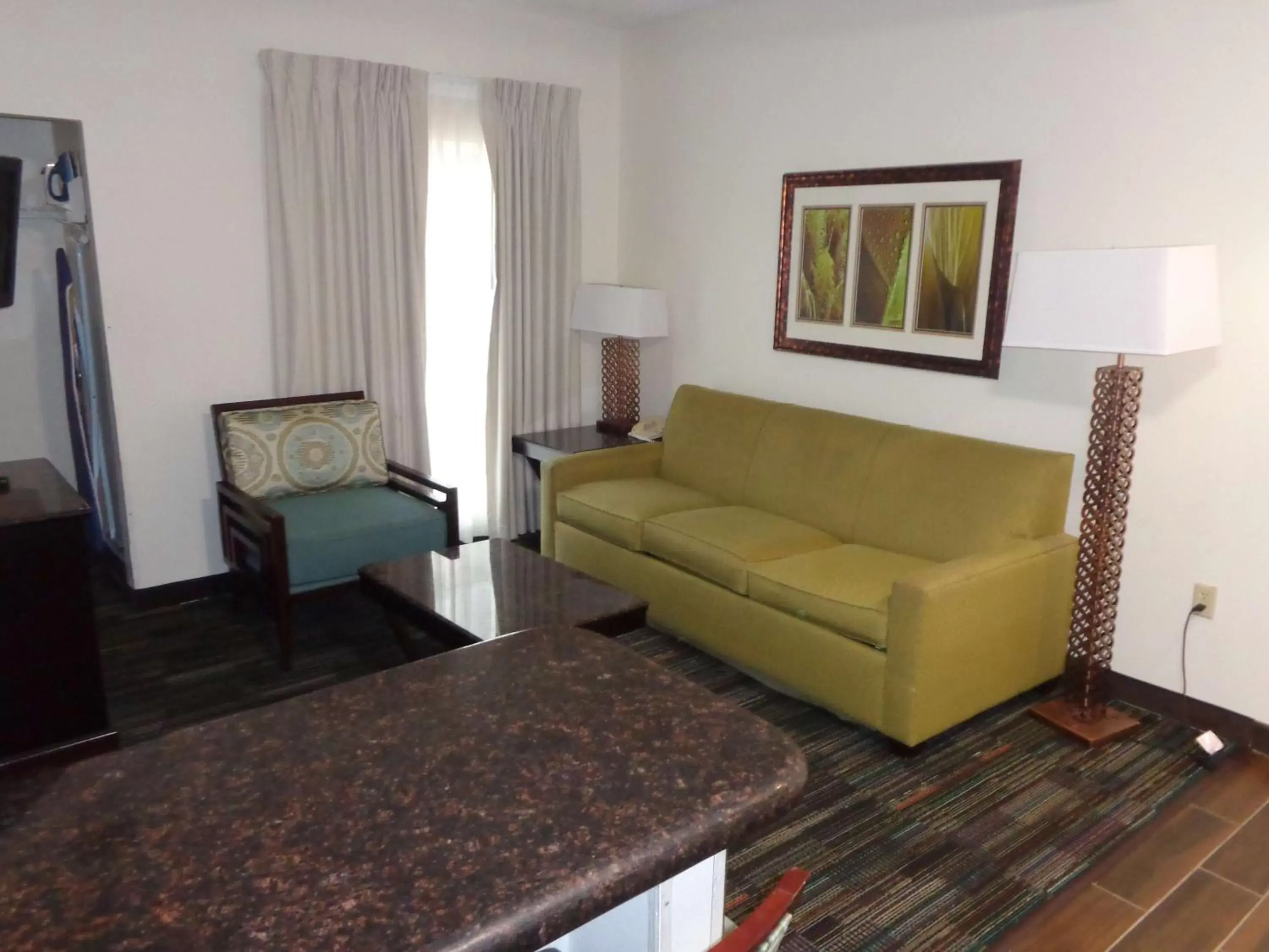 Photo of the whole room, Seating Area in SureStay Plus by Best Western Orlando Lake Buena Vista