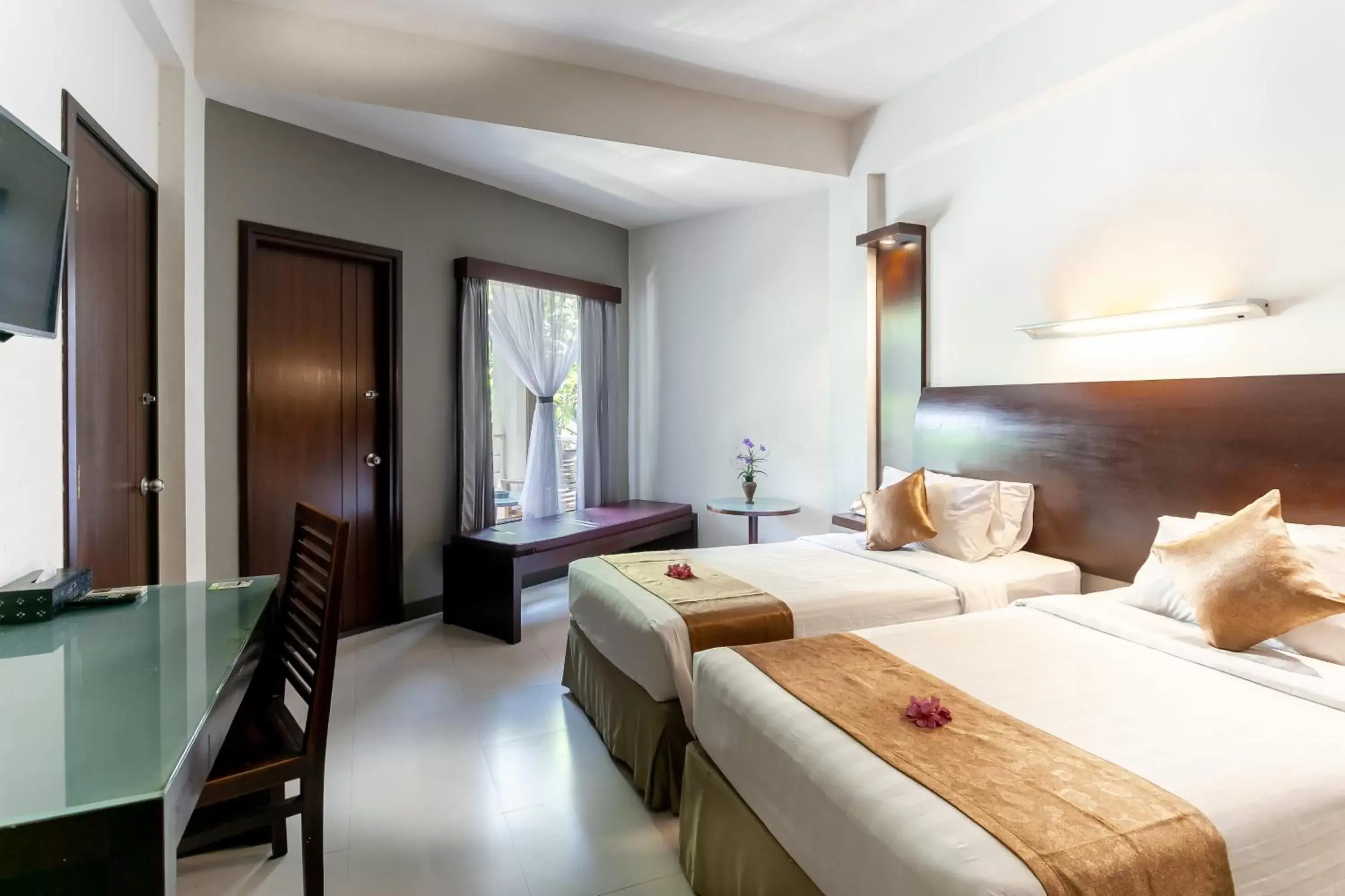 Communal lounge/ TV room, Bed in Lombok Garden Hotel