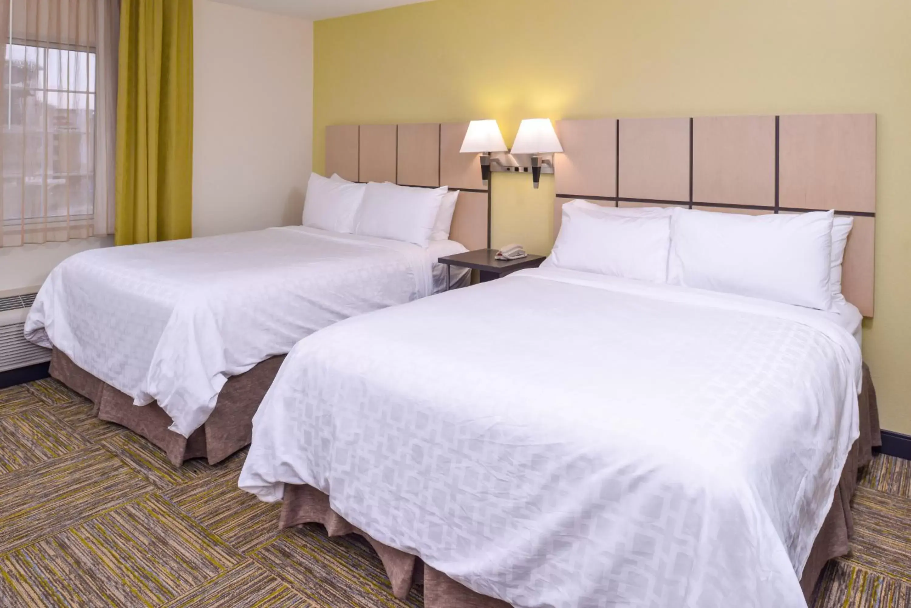 Bed in Candlewood Suites - Plano North, an IHG Hotel