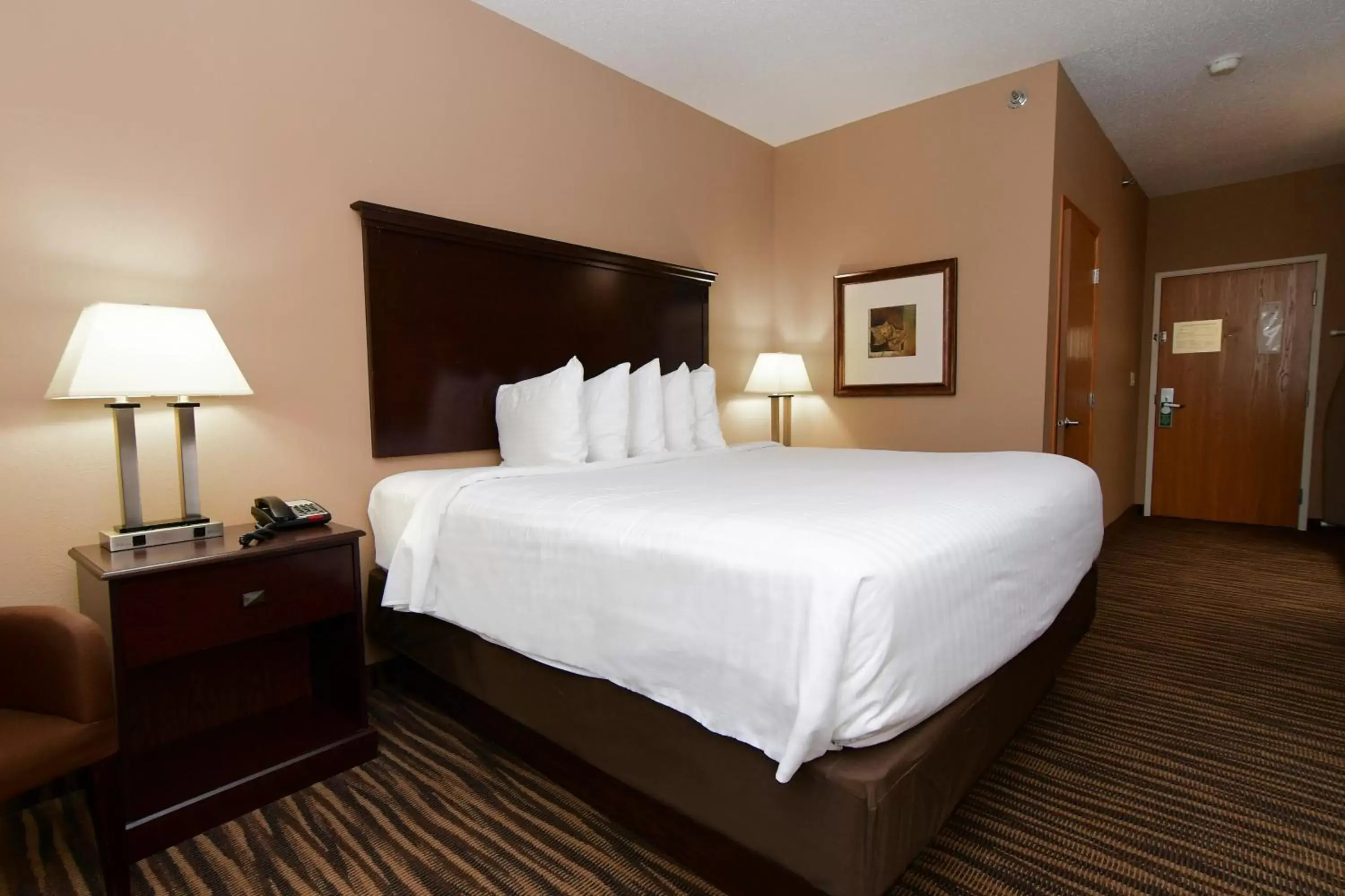 Bed in Cobblestone Inn & Suites - Denison | Majestic Hills