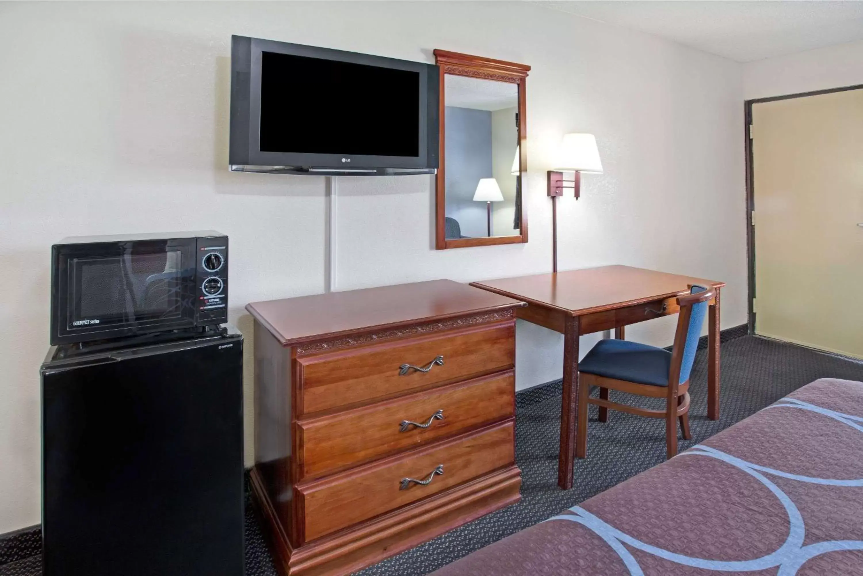 Photo of the whole room, TV/Entertainment Center in Super 8 by Wyndham Suwanee