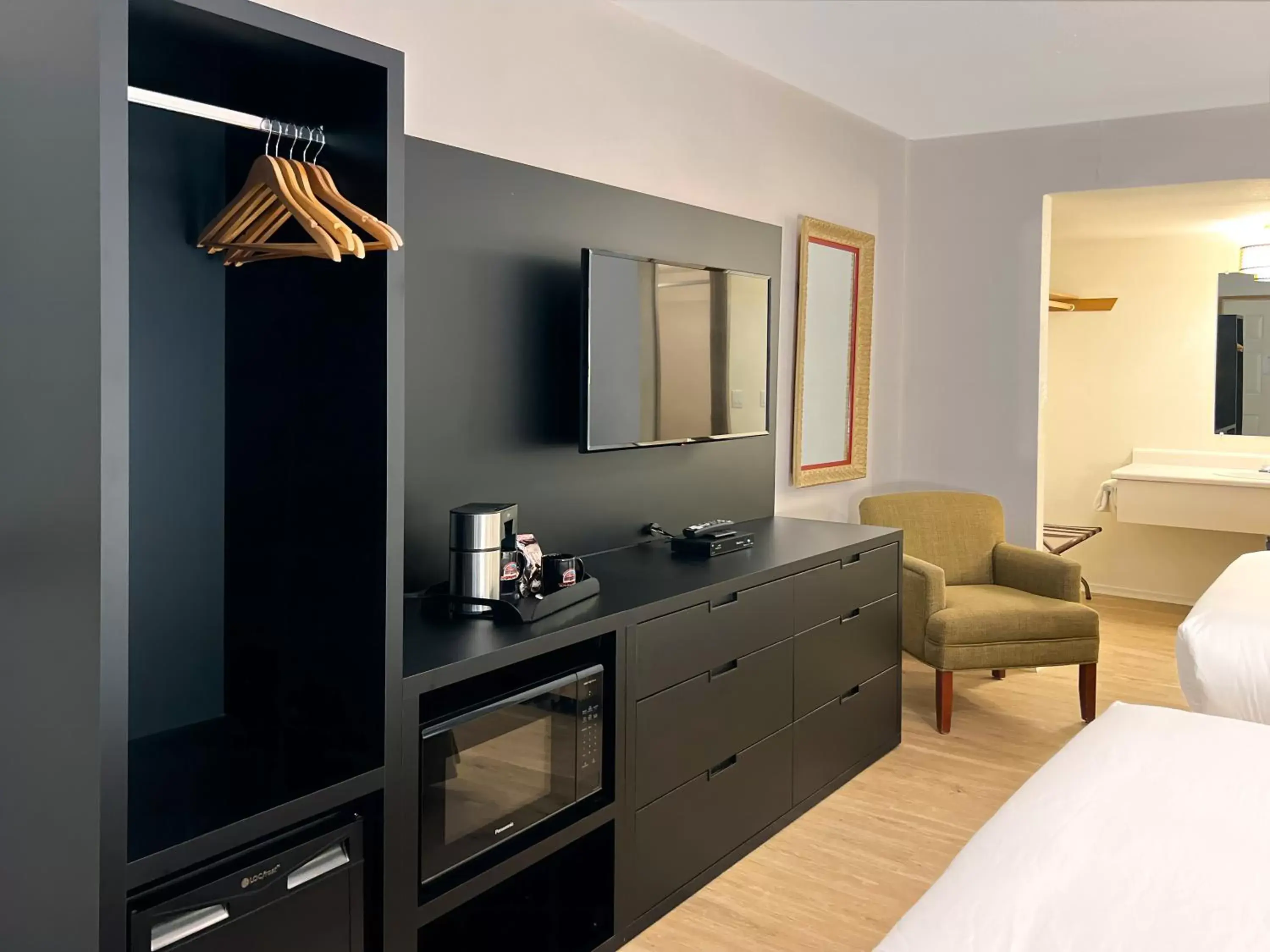 Bed, TV/Entertainment Center in The Downtown, a Coast Hotel