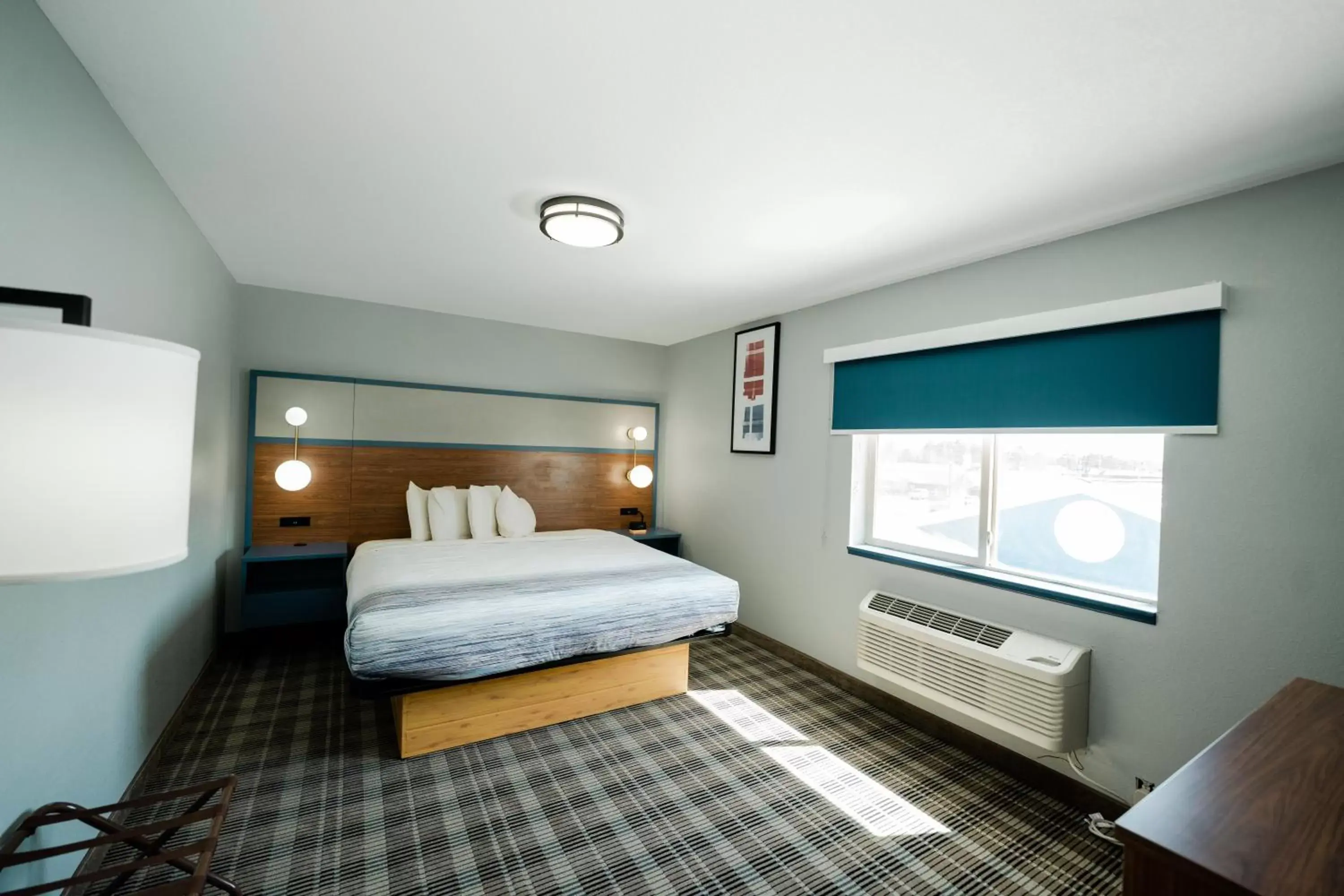 Bed in AmericInn by Wyndham Tomahawk