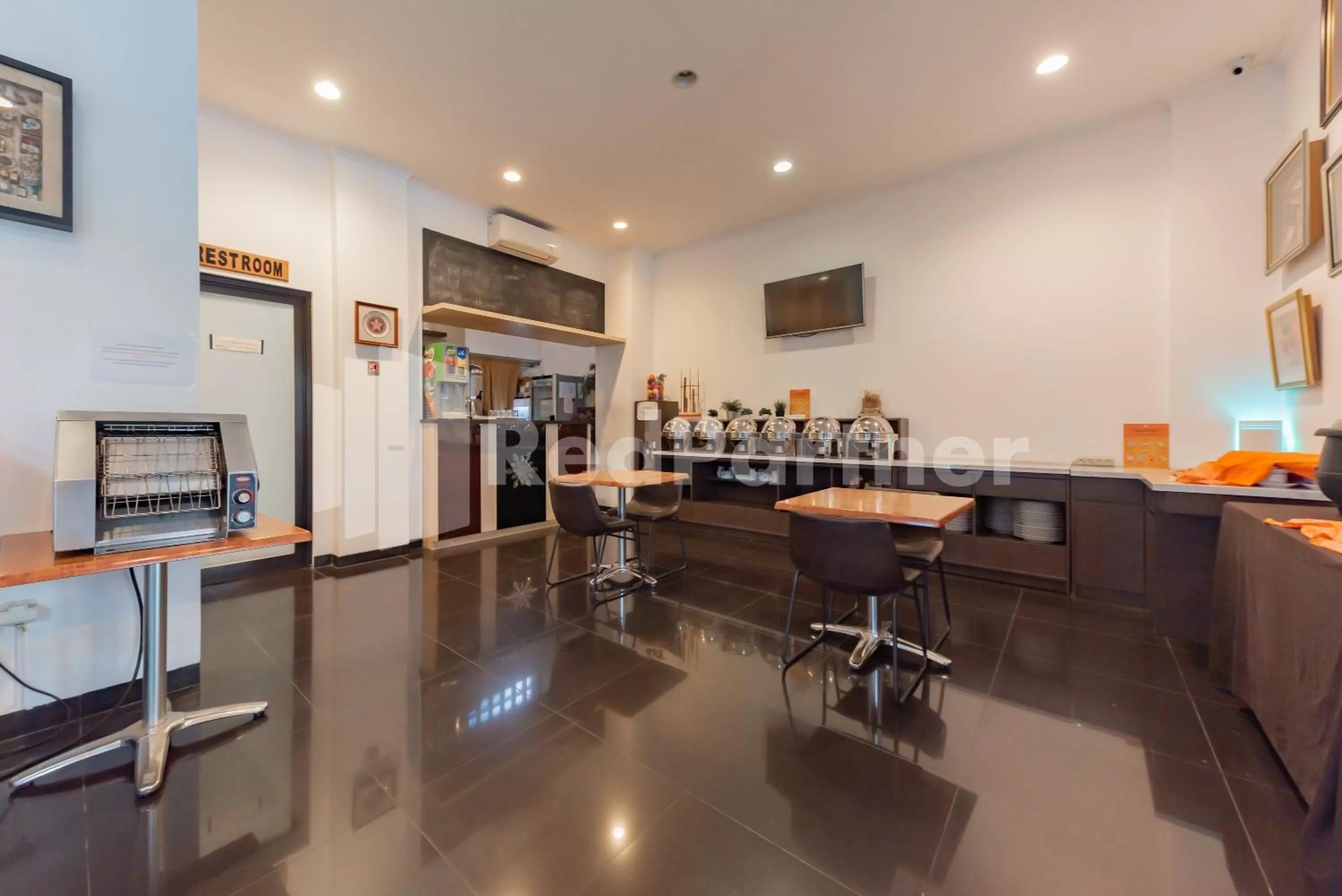 Dining area in Alqueby Hotel near Kiara Artha Park & Trans Studio Mall Mitra RedDoorz