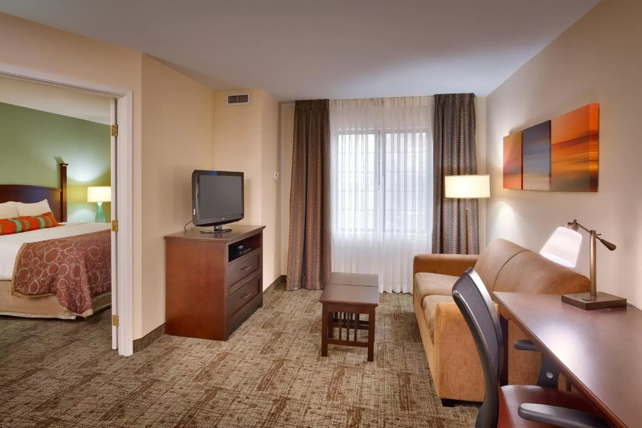 Bedroom, TV/Entertainment Center in Staybridge Suites Peoria Downtown, an IHG Hotel
