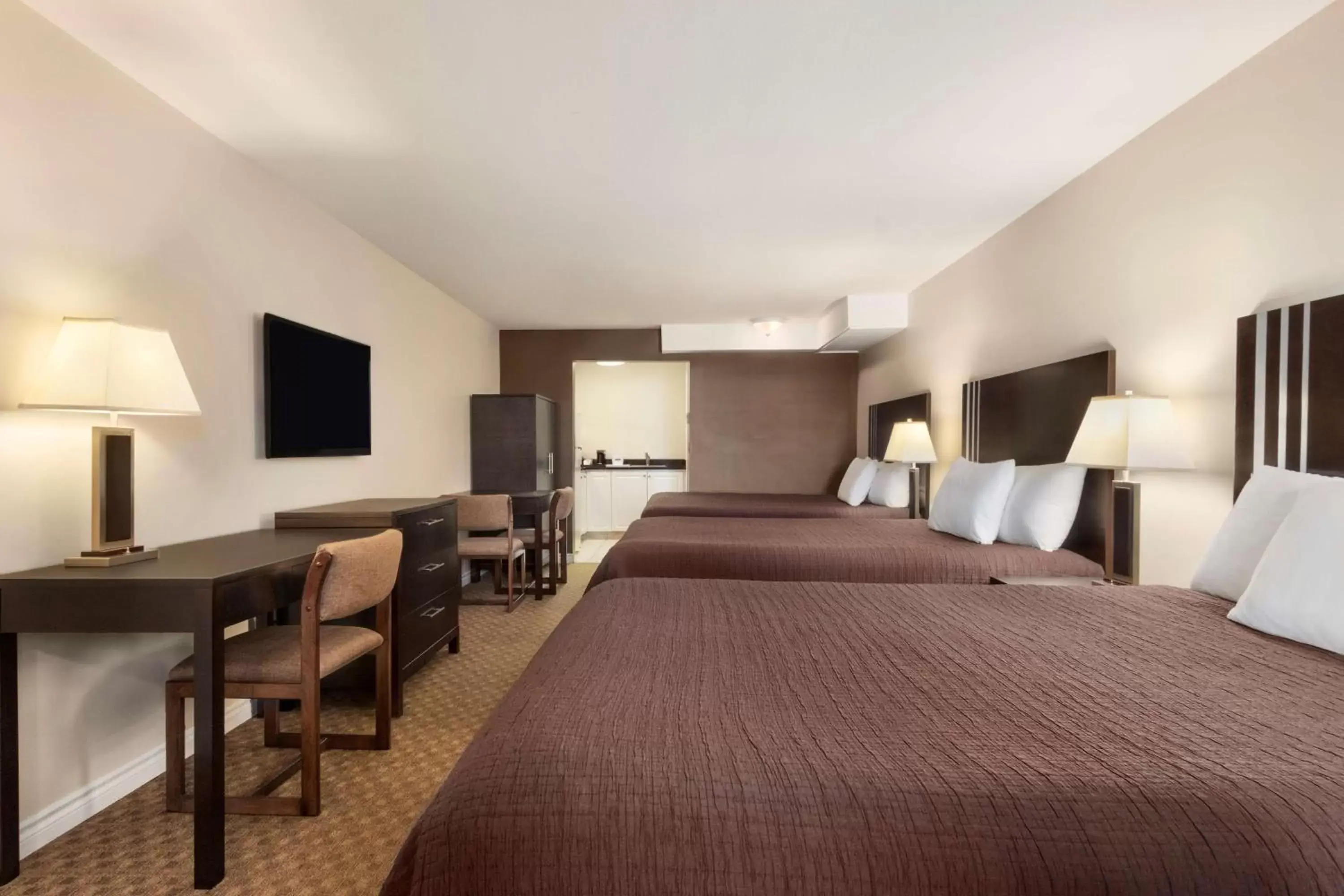 Three Queen Beds with Kitchenette in Travelodge by Wyndham Kamloops Mountview