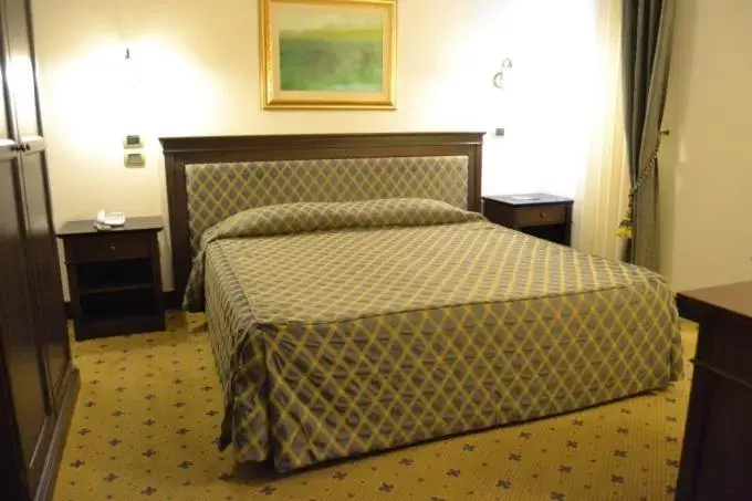 Bed in Hotel Don Carlo