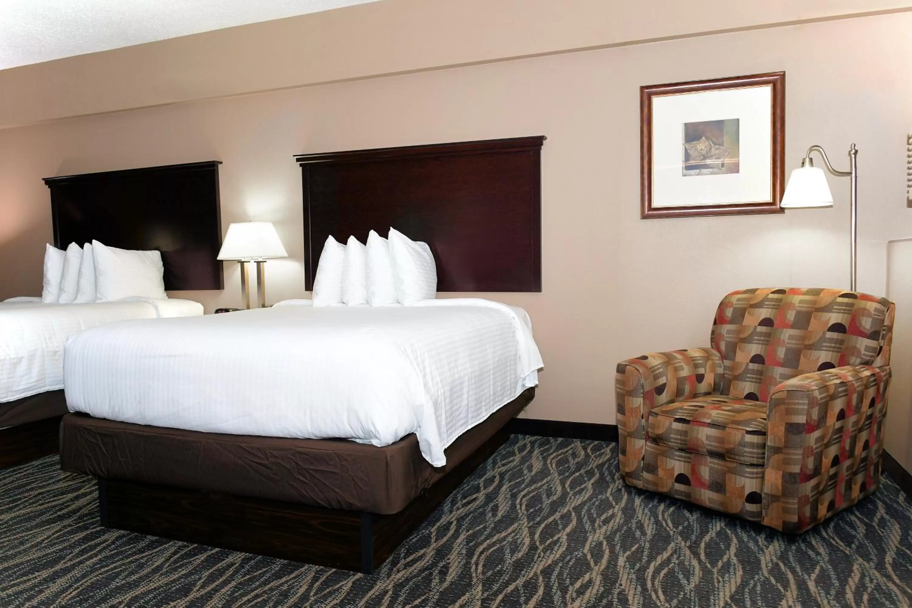 Bed in Cobblestone Inn & Suites - Denison | Majestic Hills