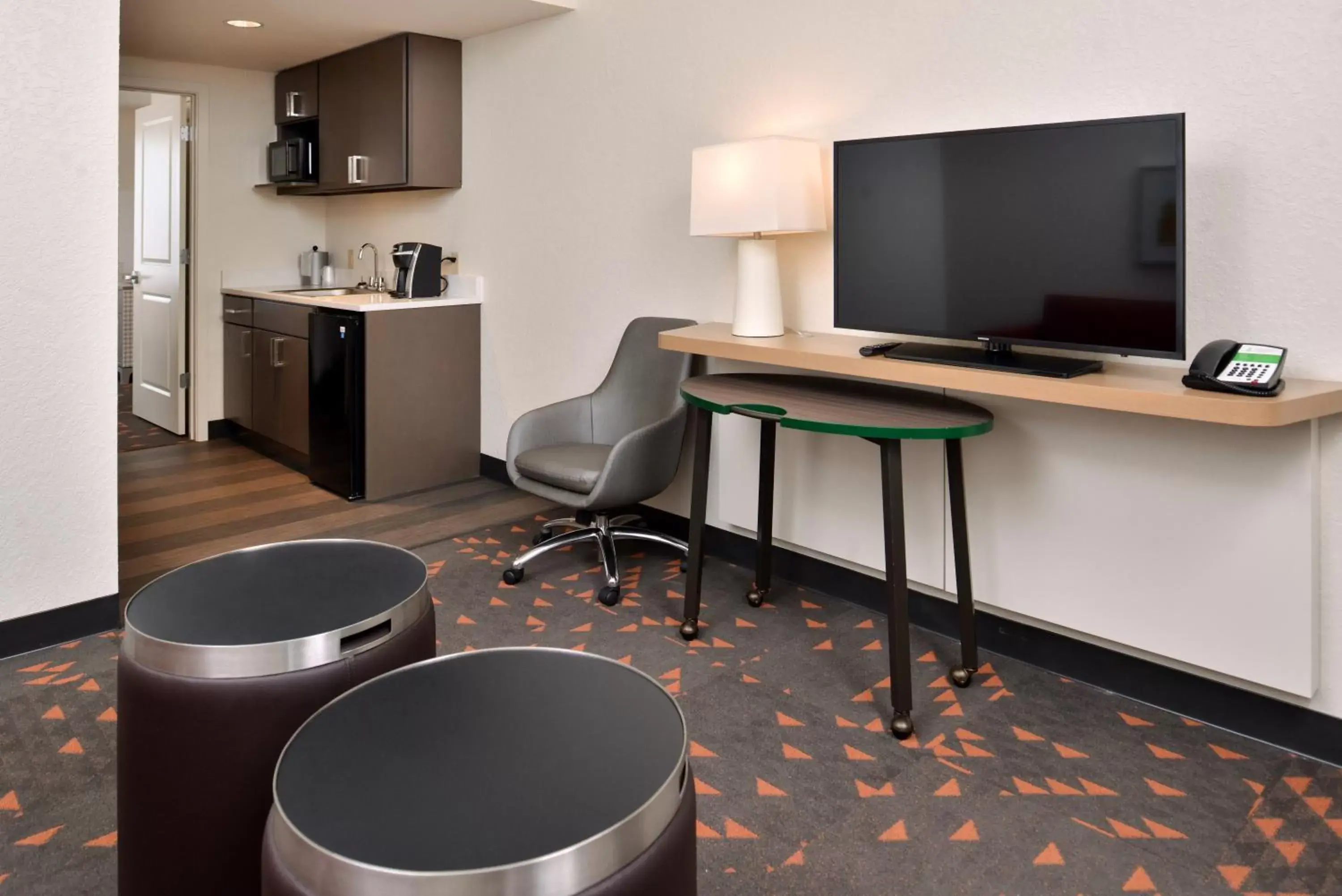 Photo of the whole room, TV/Entertainment Center in Holiday Inn & Suites Orlando - International Dr S, an IHG Hotel