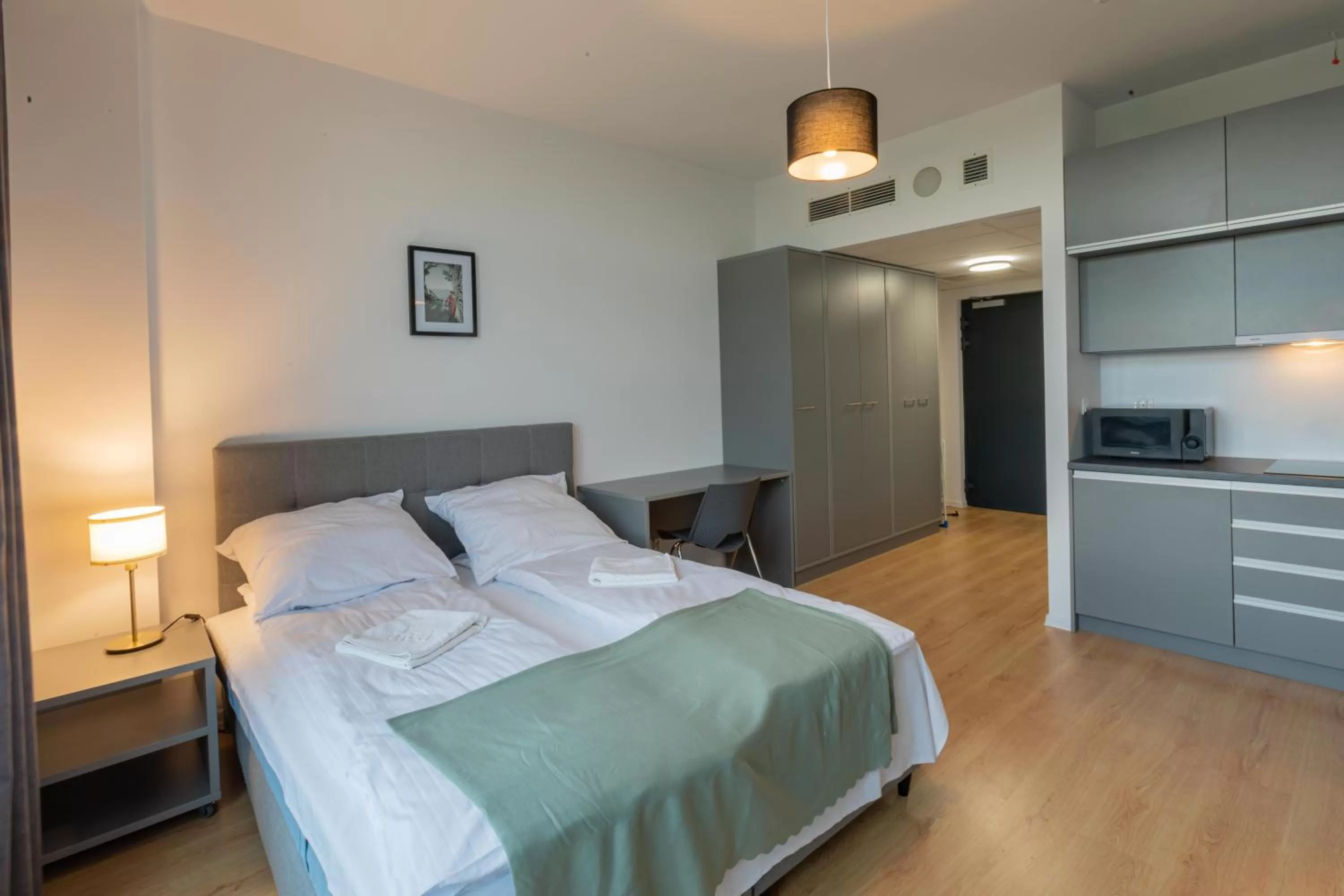 Bed in SleepWell Apartments