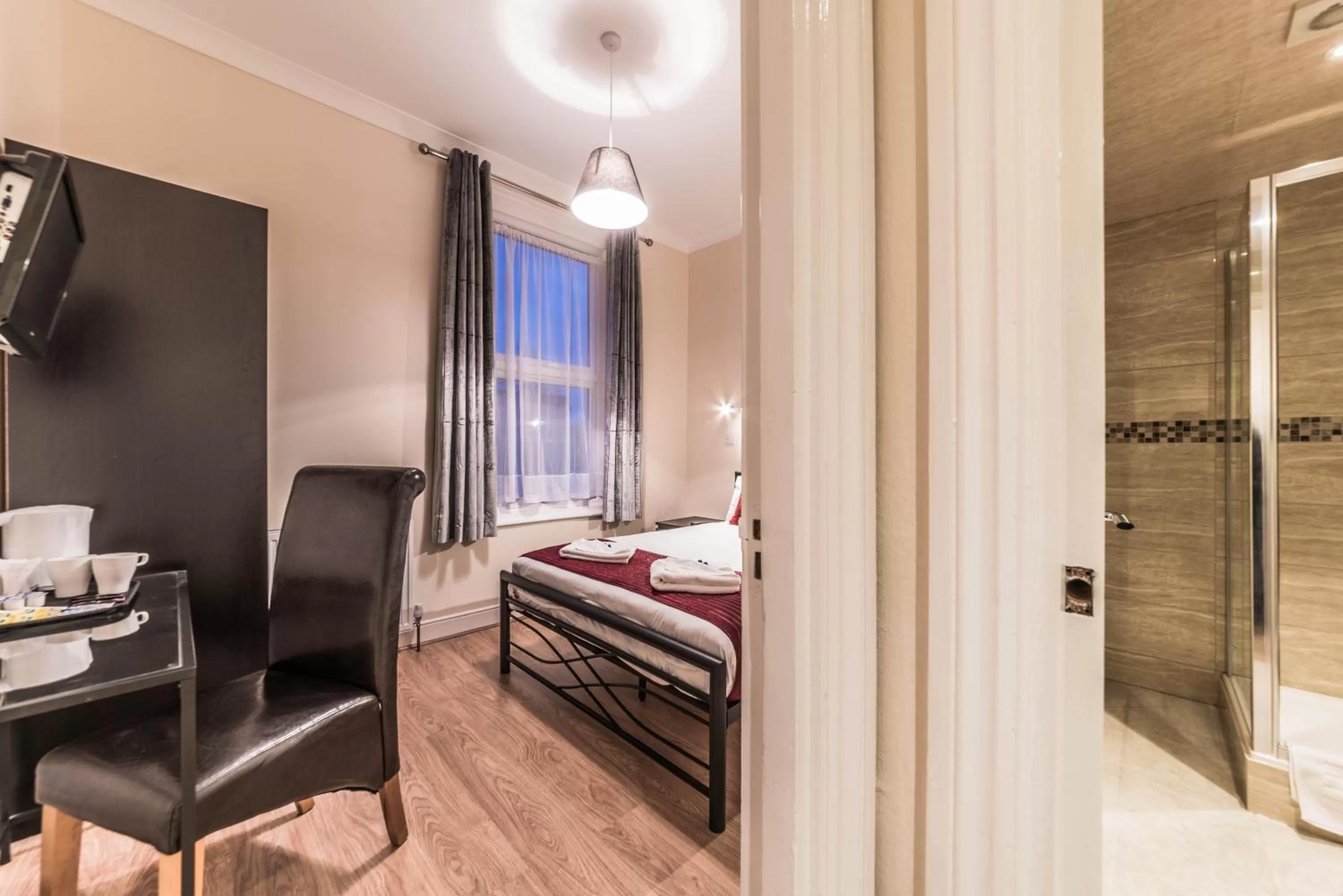 Bed, TV/Entertainment Center in Hellenic Hotel by Saba