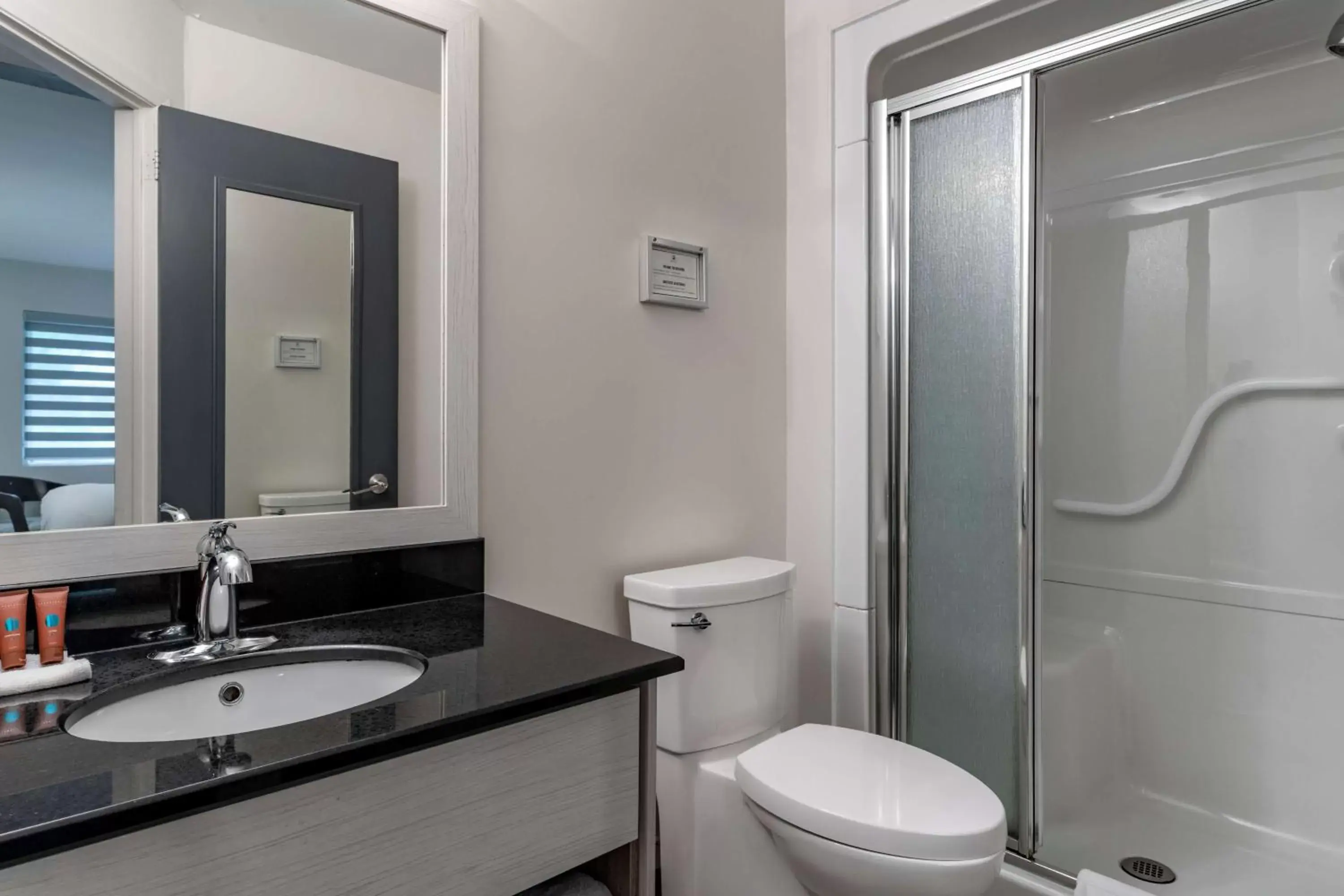 Bathroom in Dannys Hotel Suites; SureStay Collection by Best Western