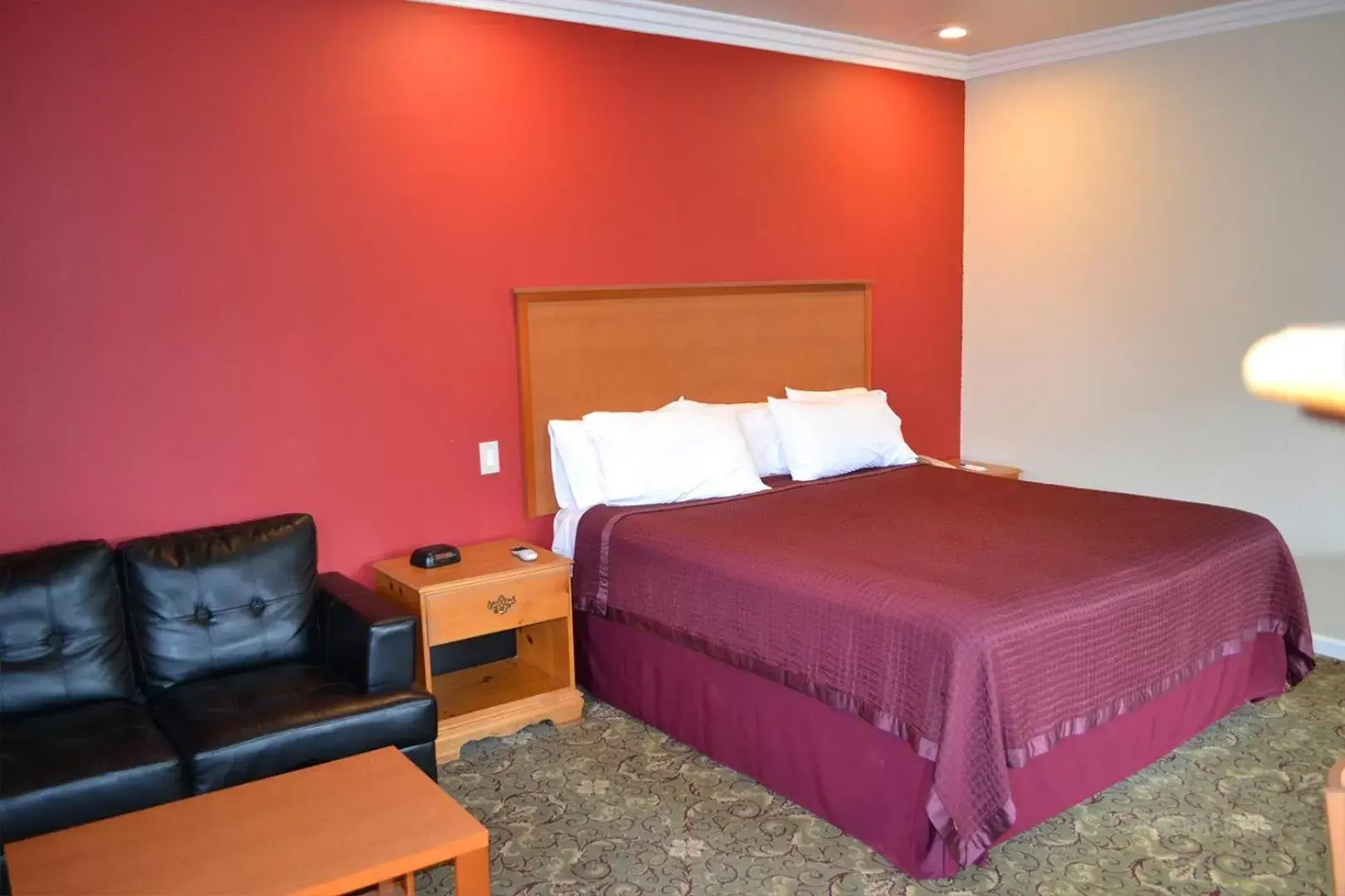 Bed in The Miramar Inn & Suites
