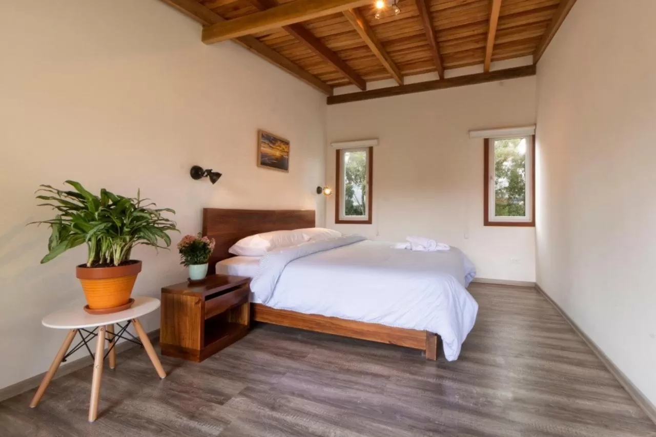 Bed in Hosteria Papagayo Cotopaxi