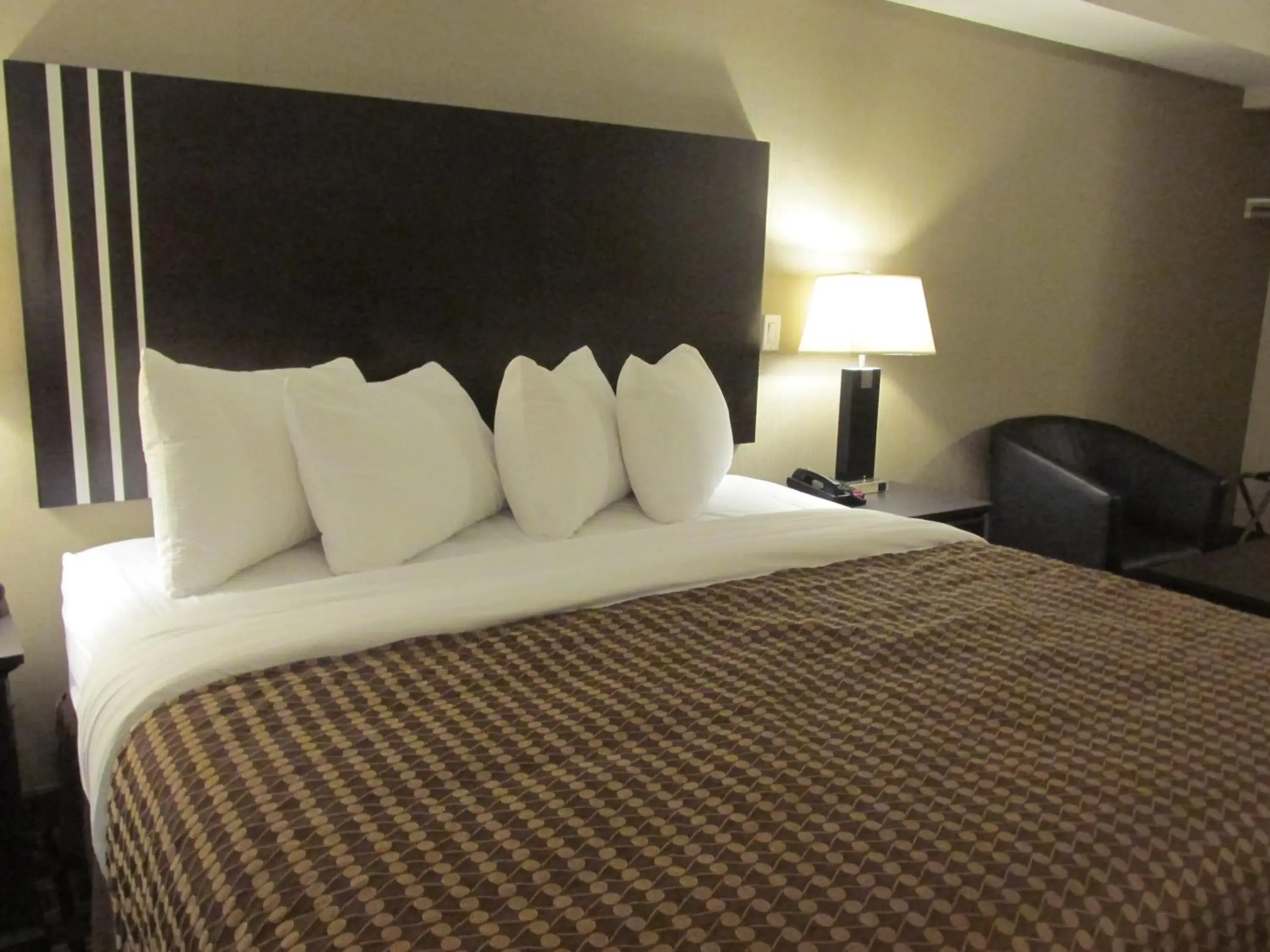 Bed in Sigma Inn & Suites