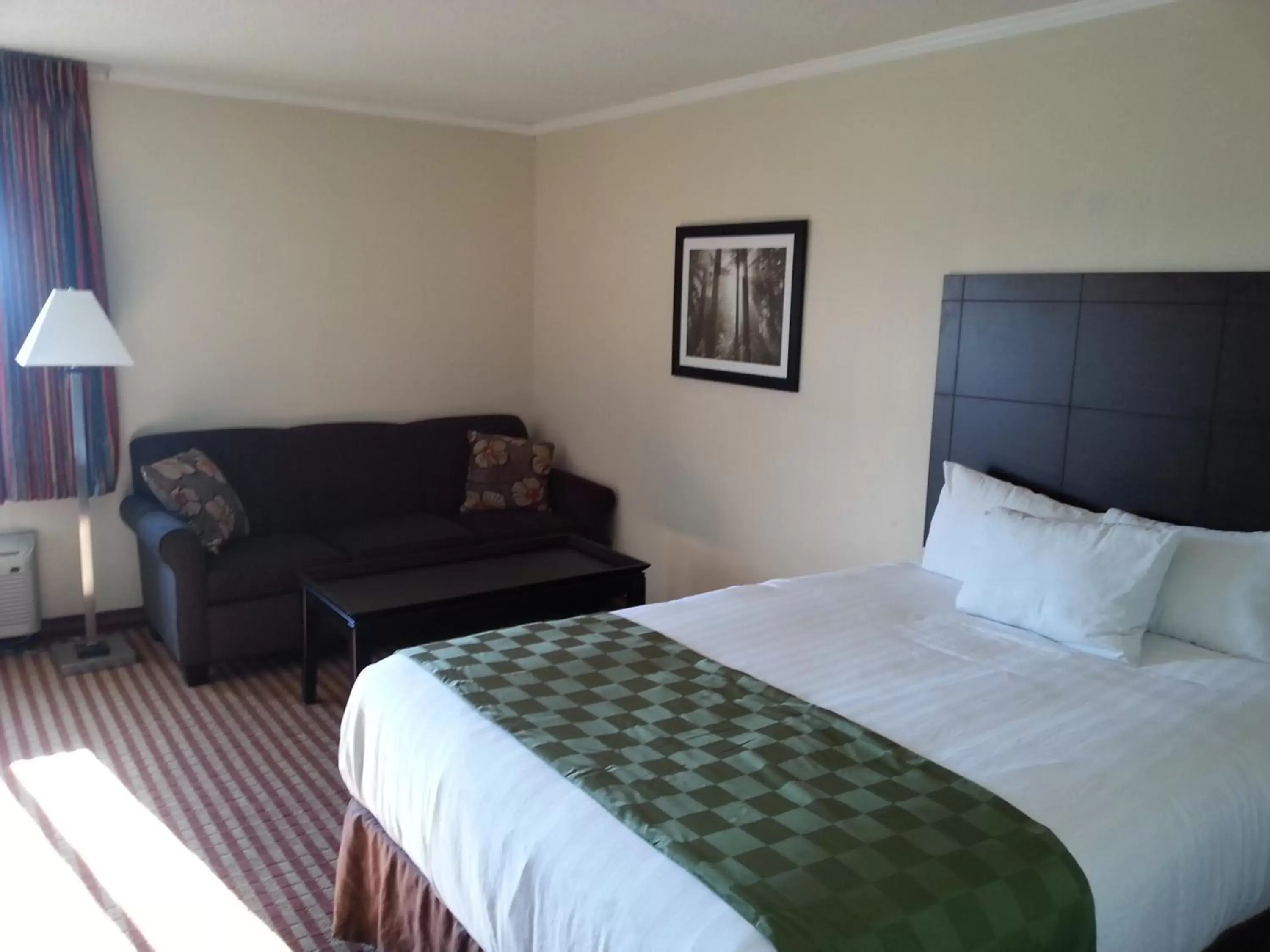 Seating area, Bed in Days Inn & Suites by Wyndham Kansas City - Royals Stadium