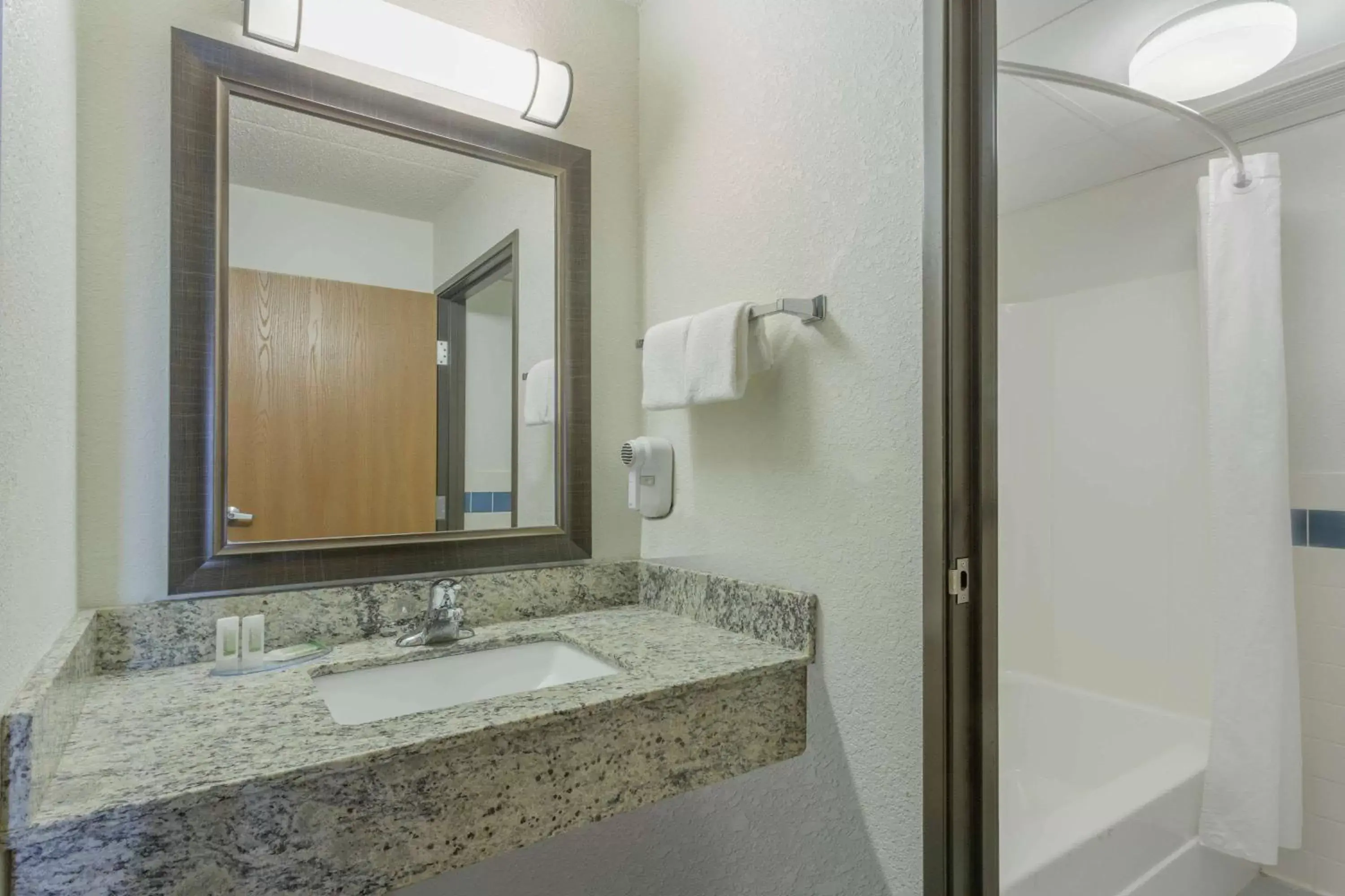 Bathroom in AmericInn by Wyndham Menominee