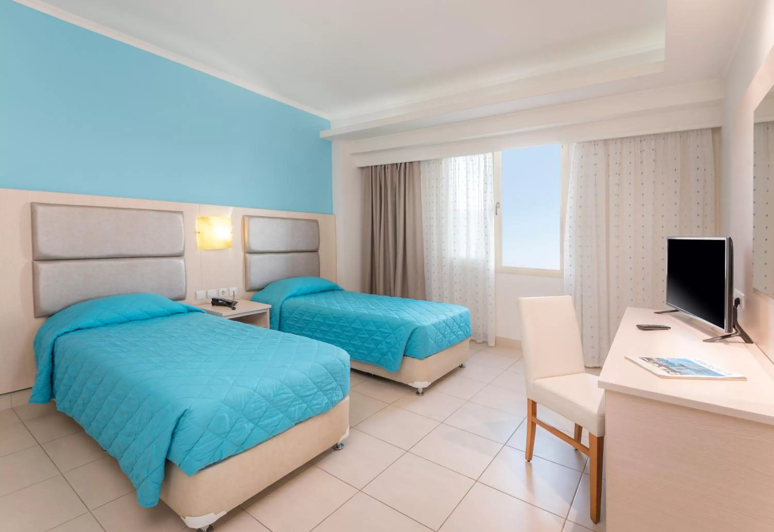 Bed in Grand Blue Beach Hotel