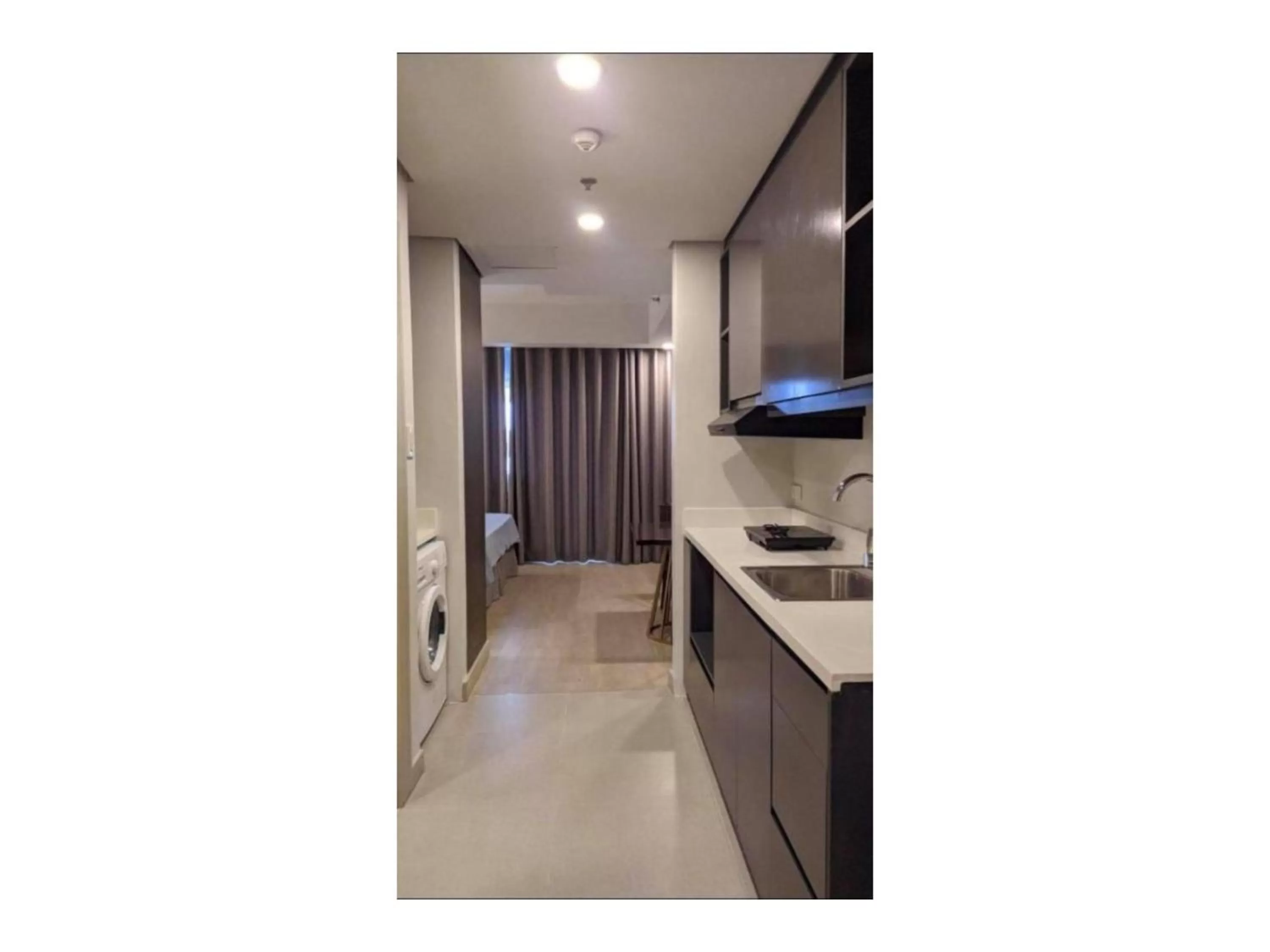 Living room, Kitchen/Kitchenette in Capital O 804 The Residences at Bonifacio Civic Center