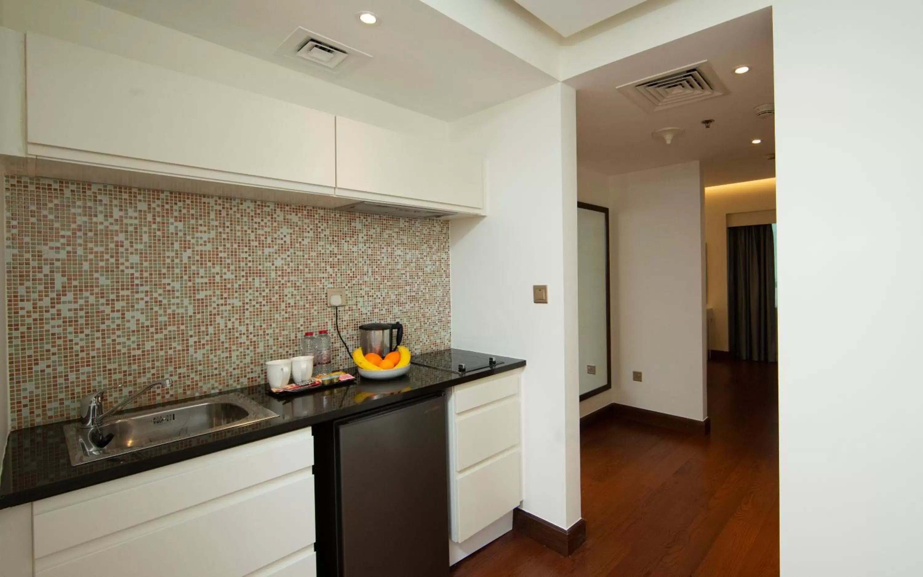 Kitchen or kitchenette in Number One Tower Suites Hotel