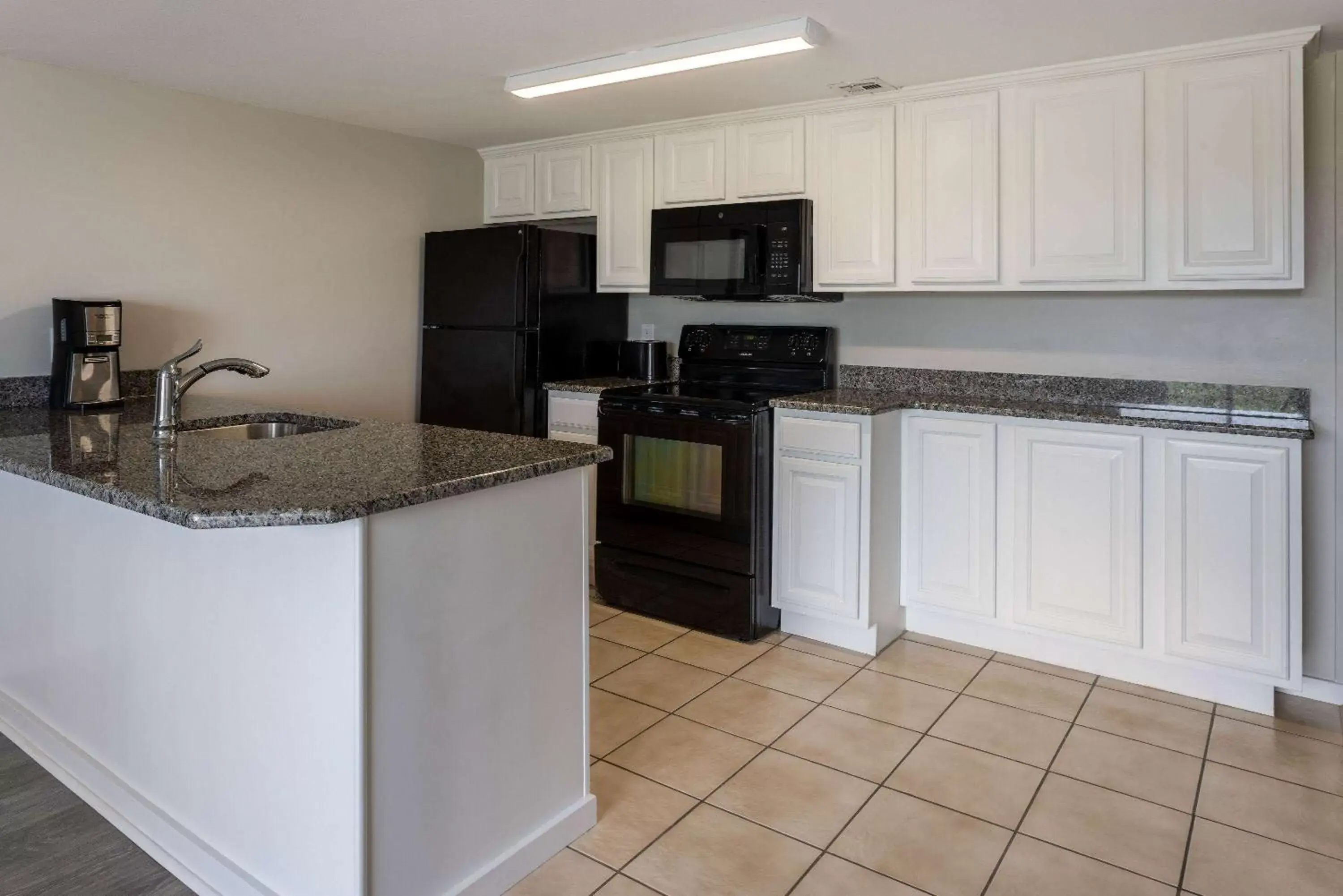 Bed, Kitchen/Kitchenette in Atlantic Beach Resort, a Ramada by Wyndham