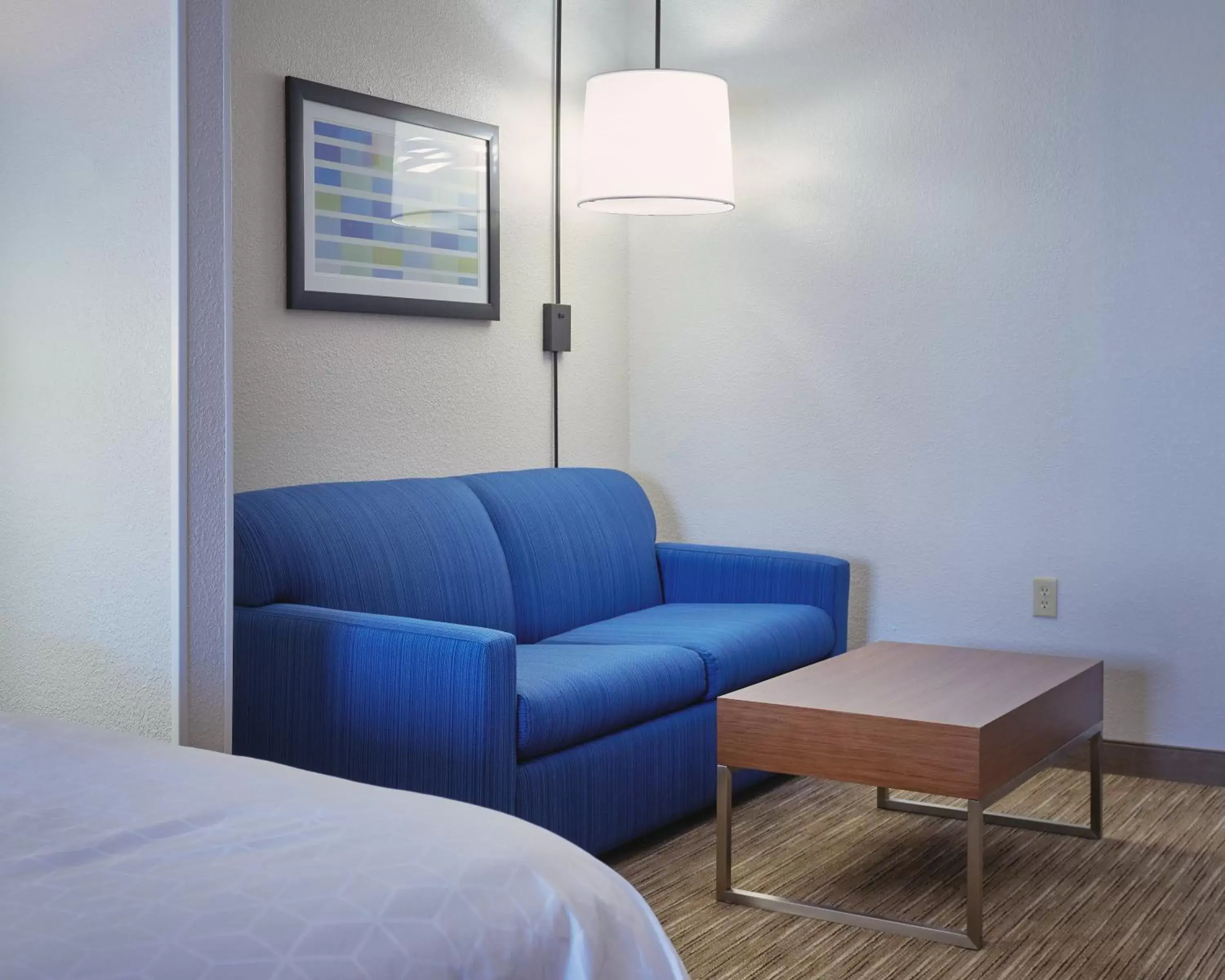 Bedroom, Seating Area in Holiday Inn Express Hotel and Suites Akron South-Airport Area, an IHG Hotel