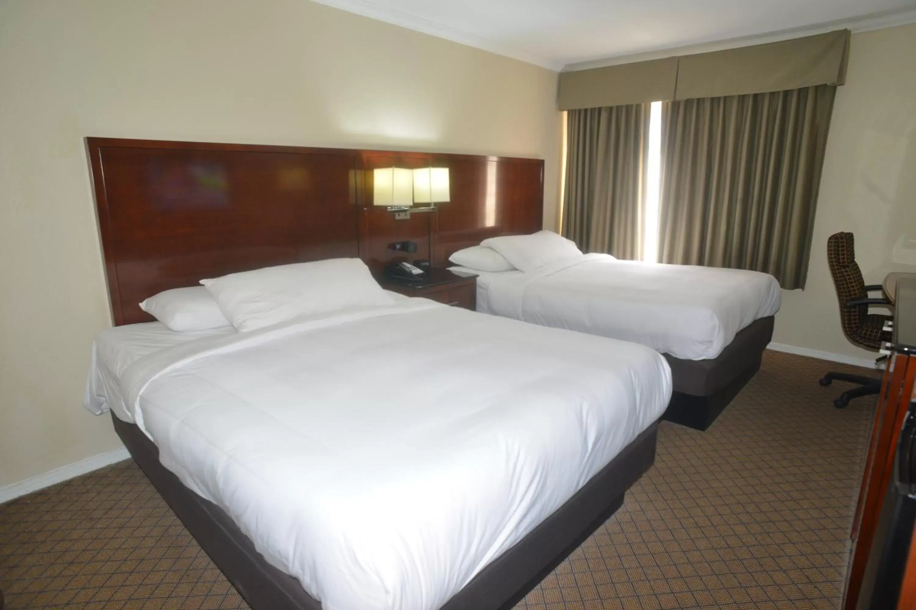 Bed in Hometown Inn & Suites