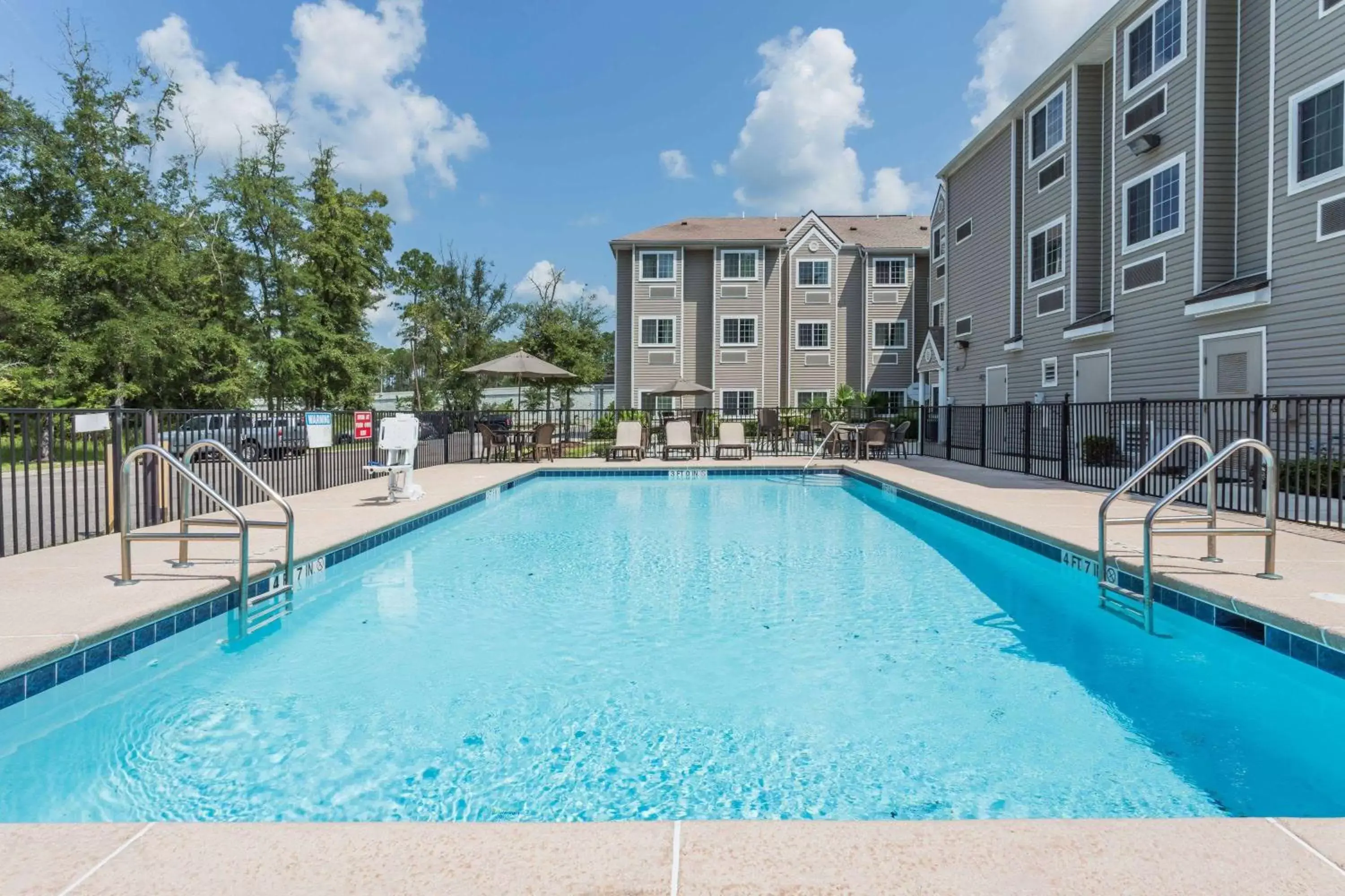 Lobby or reception, Swimming Pool in Microtel Inn & Suites by Wyndham Jacksonville Airport