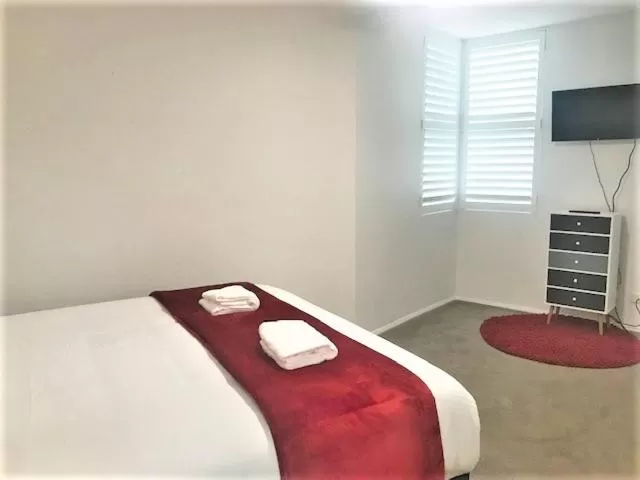 Bed in Sunrise Luxury Apartments