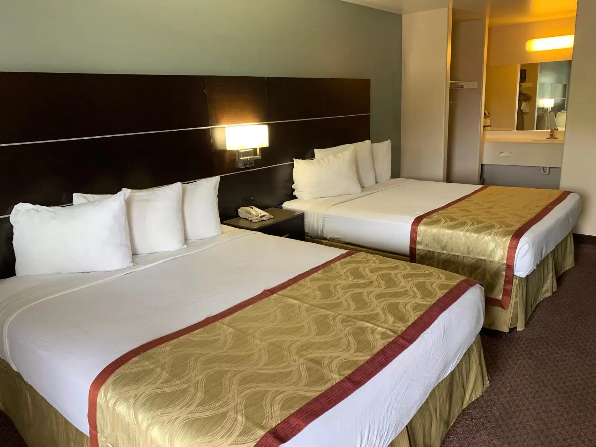 Bed in Olive Tree Inn & Suites