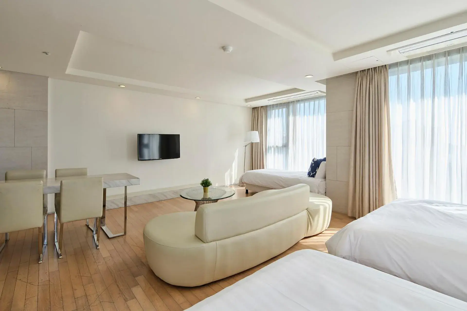 Bed, Seating Area in The Island Blue Hotel