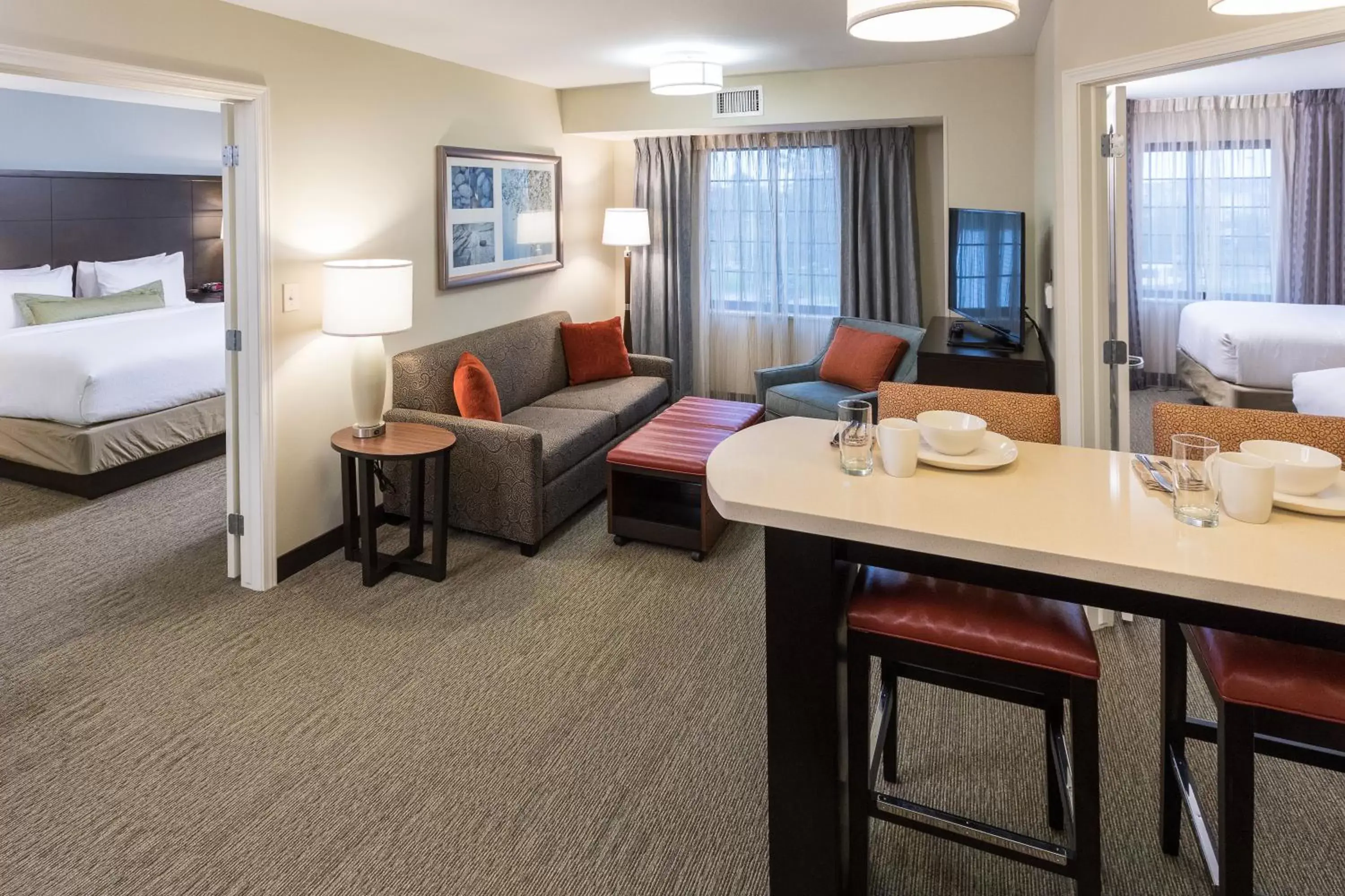 Bedroom, Seating Area in Staybridge Suites Omaha West, an IHG Hotel