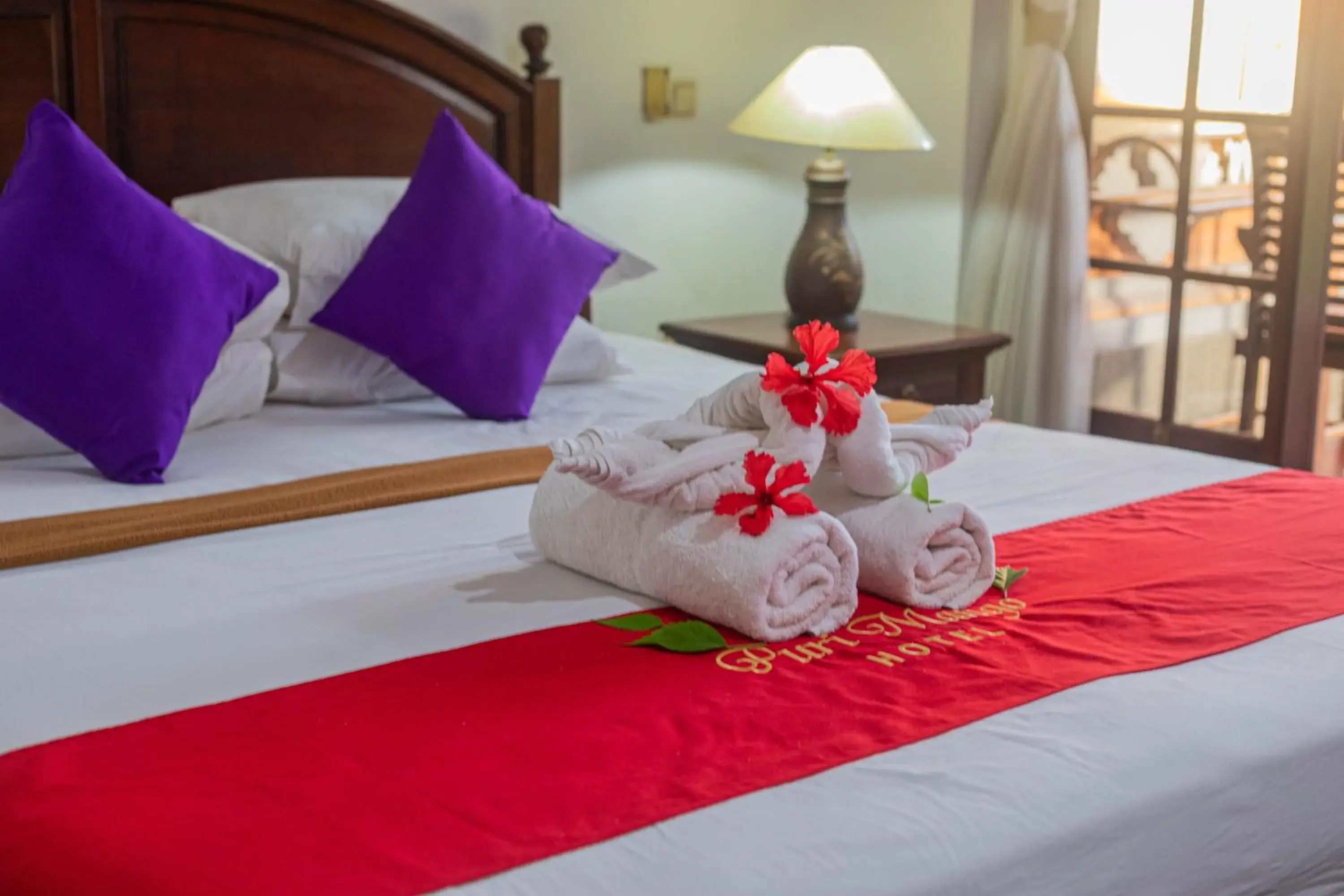 Bed in OYO 3868 Puri Mango Hotel