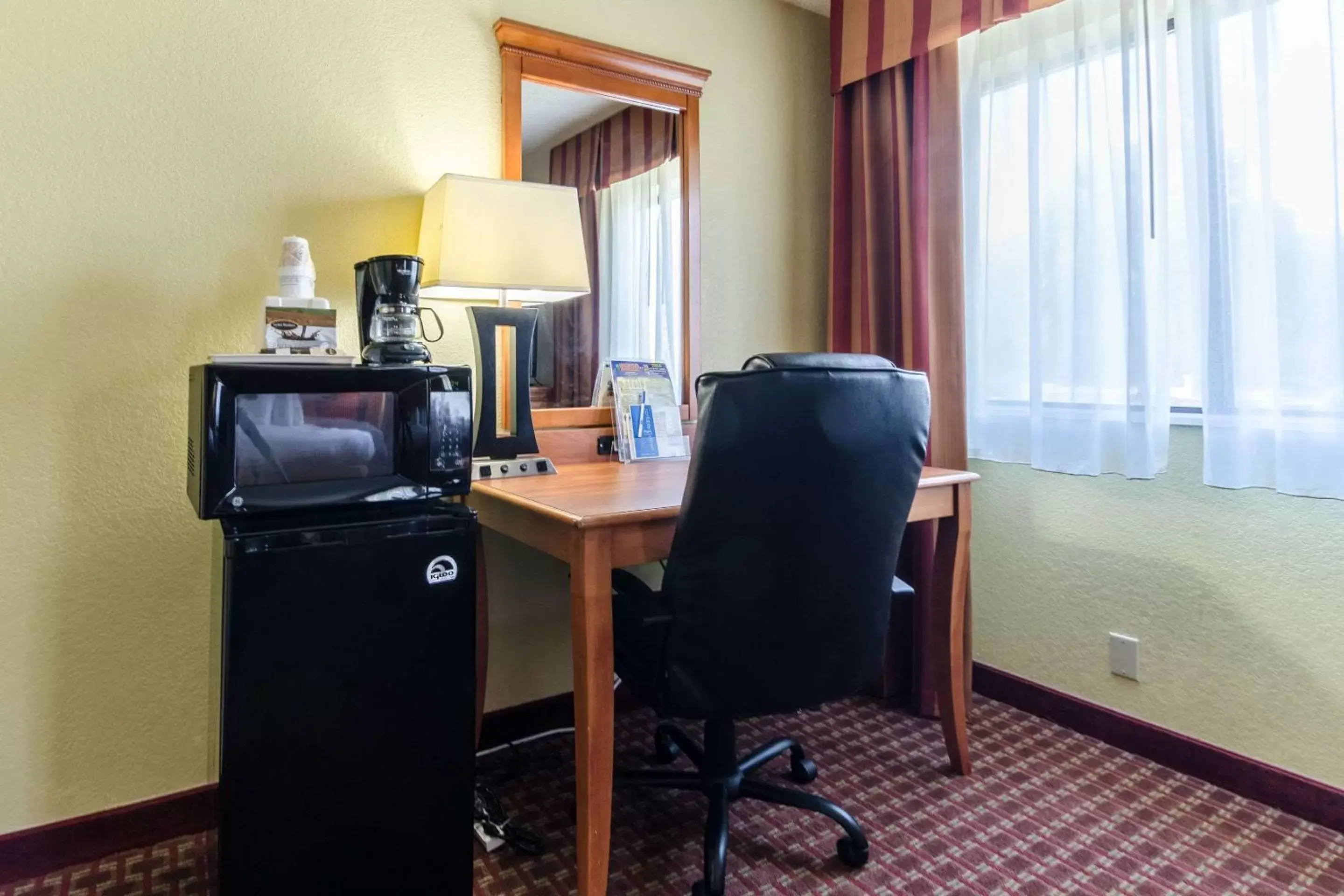 Photo of the whole room, TV/Entertainment Center in Rodeway Inn & Suites Jacksonville near Camp Lejeune