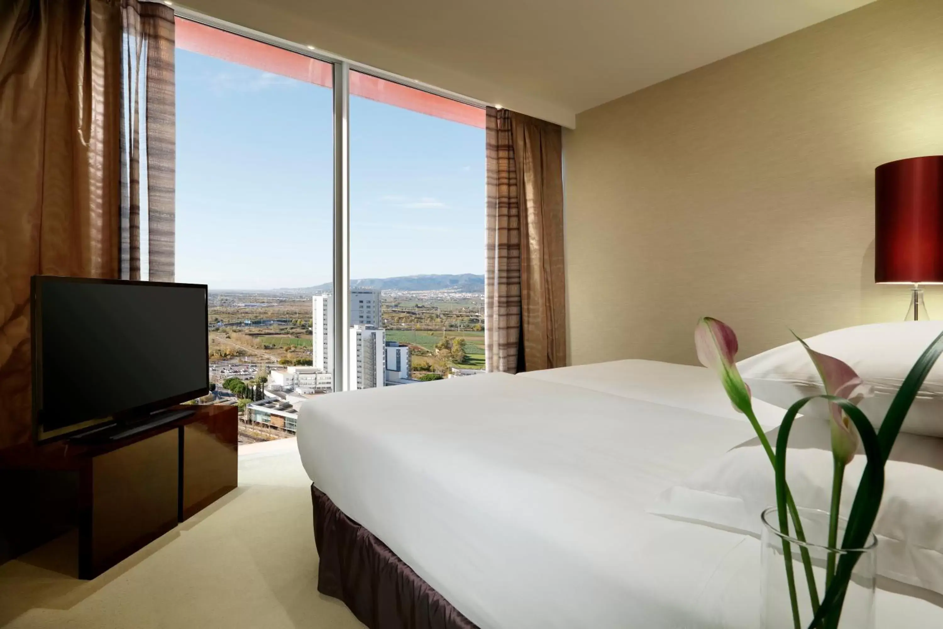 Bed in Hyatt Regency Barcelona Tower