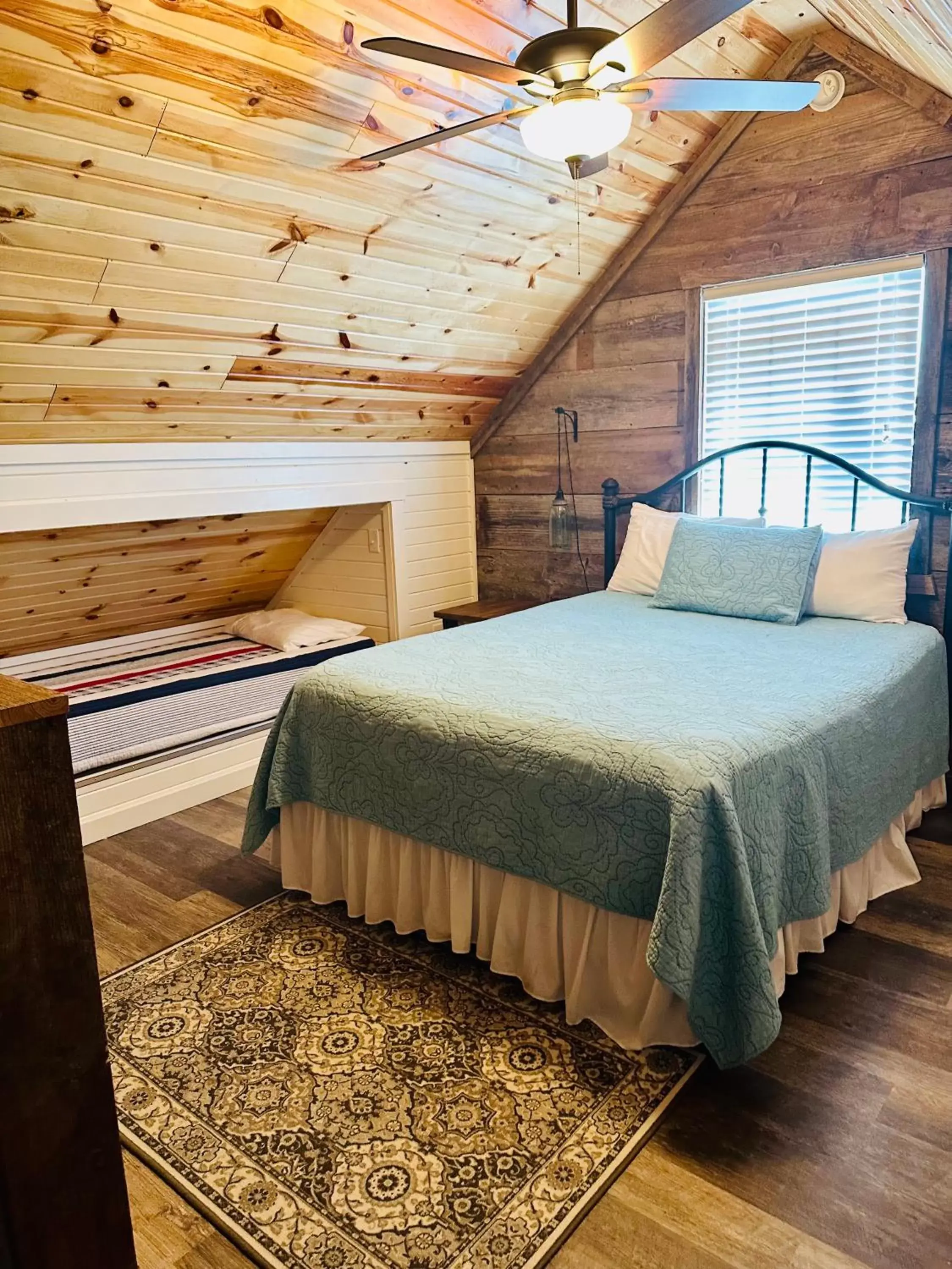 Bed in Knotty Squirrel Cabins