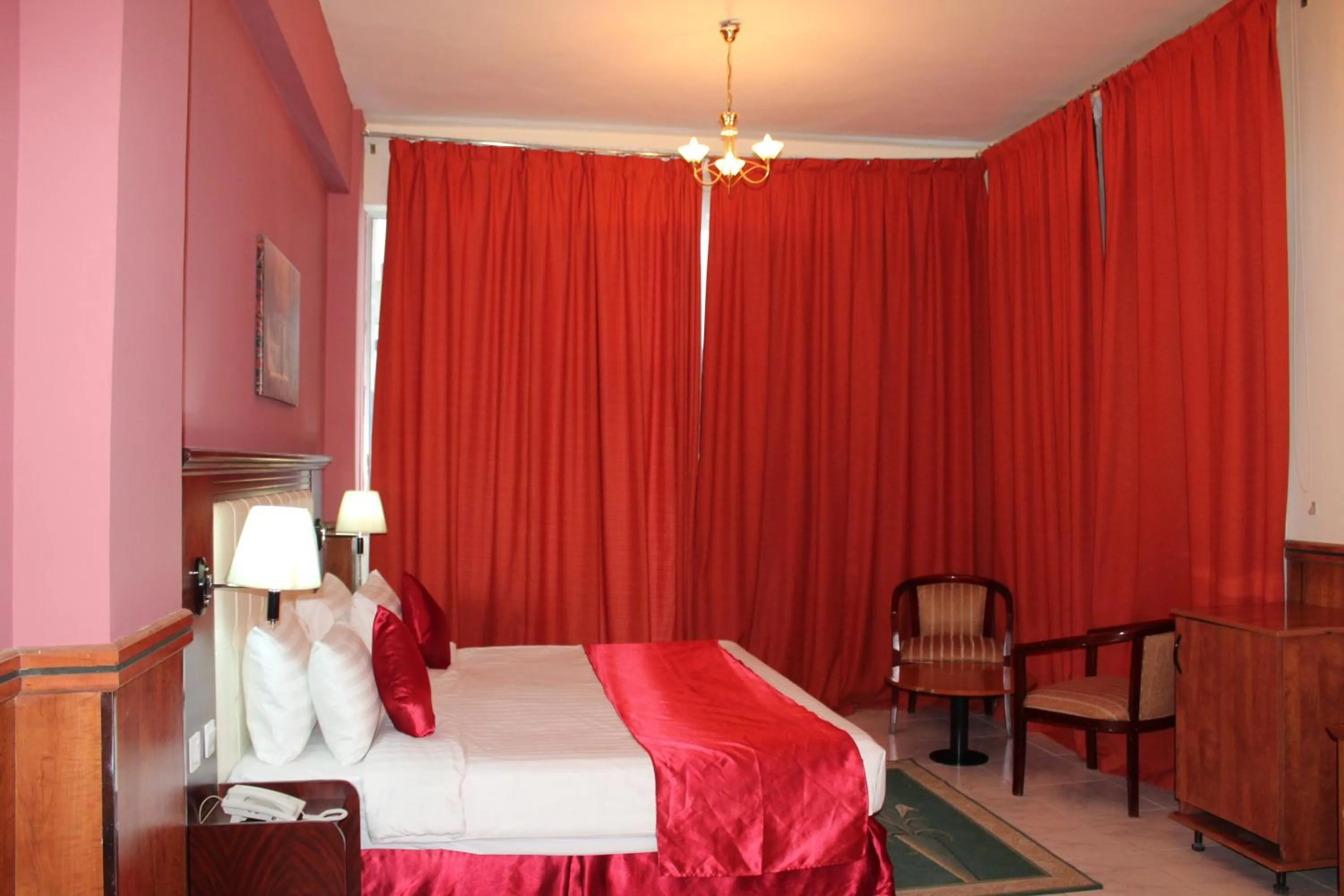 Bed in Grand Nova Hotel