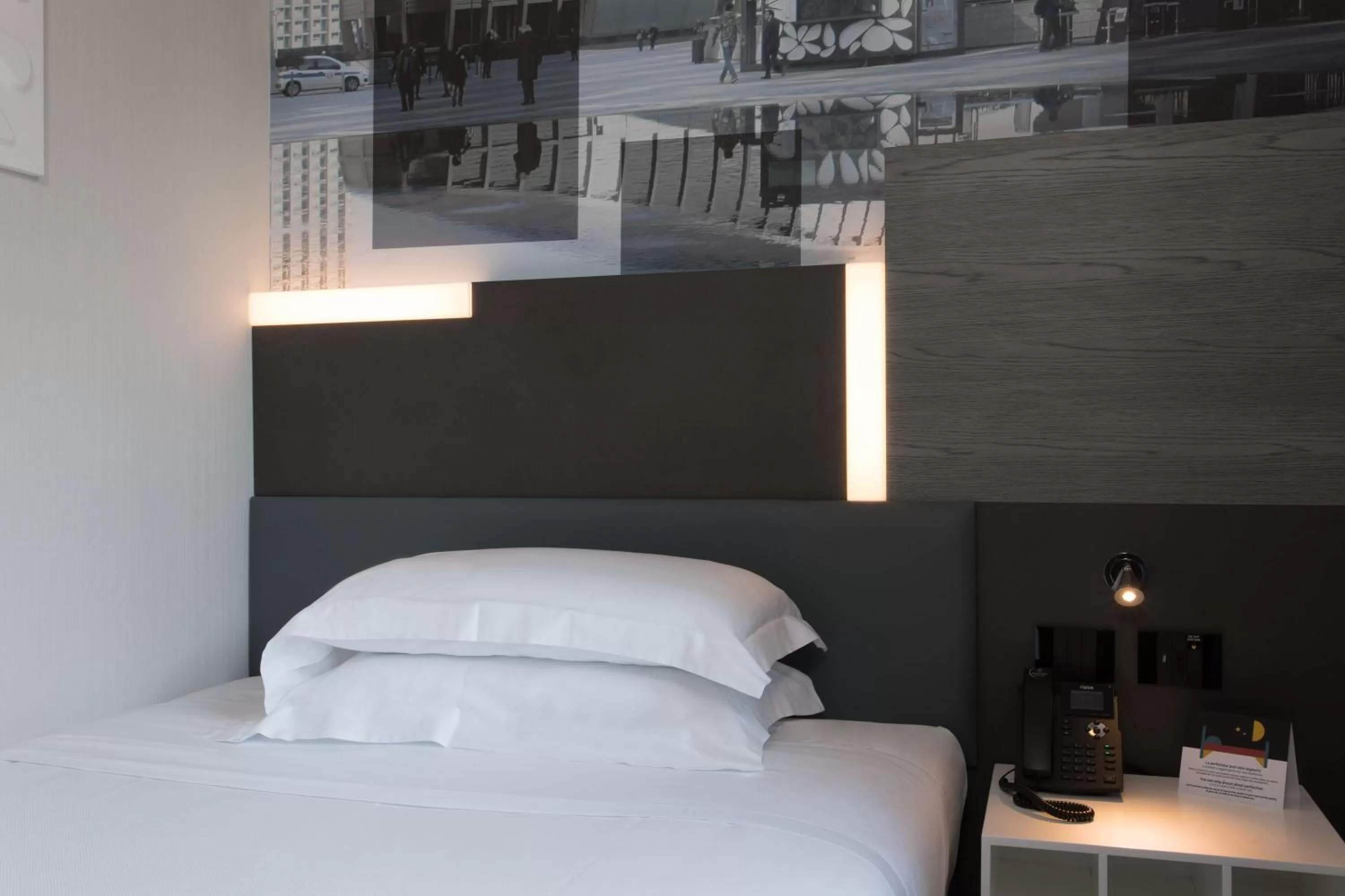 Bed in iQ Hotel Milano