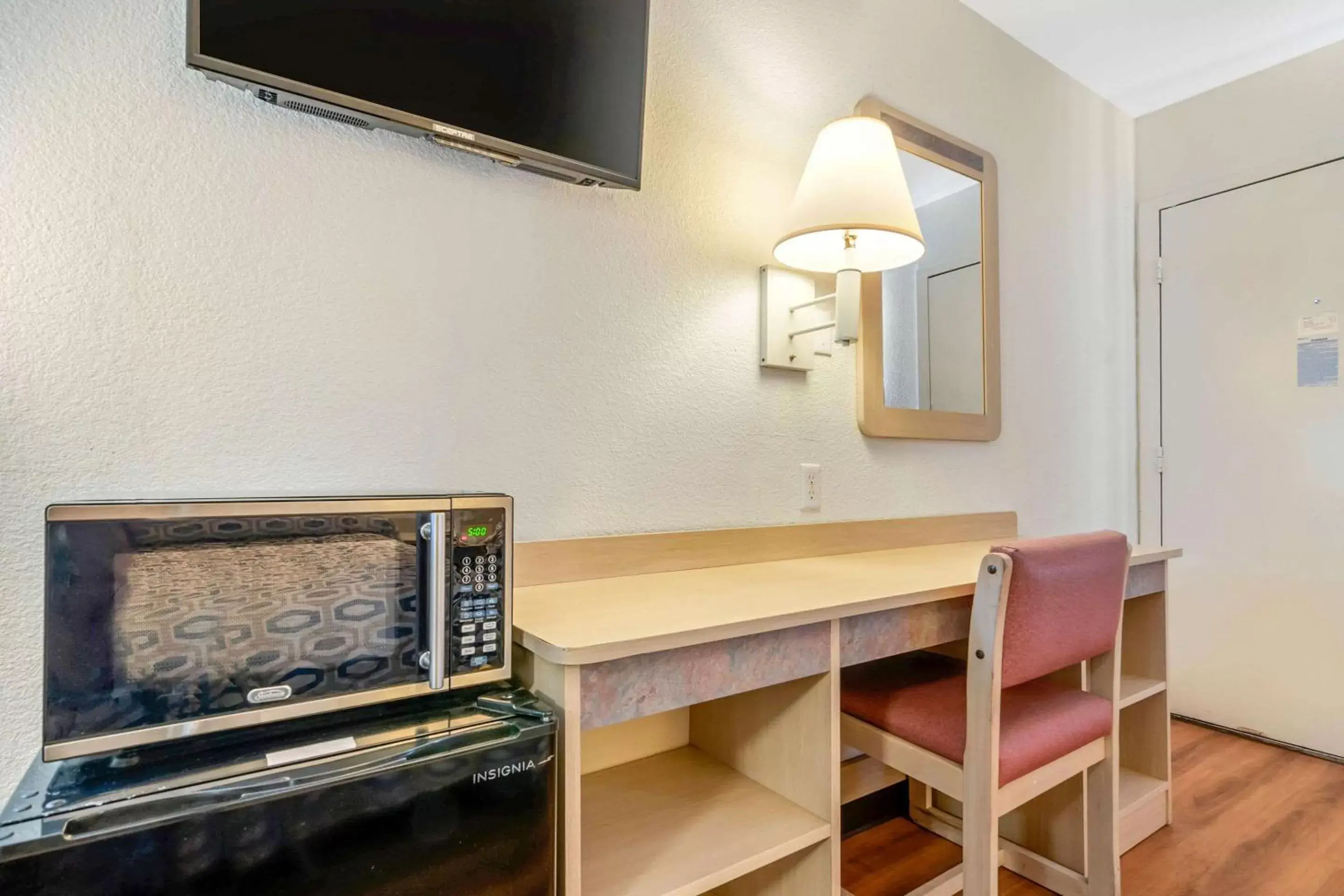 Photo of the whole room, TV/Entertainment Center in Rodeway Inn