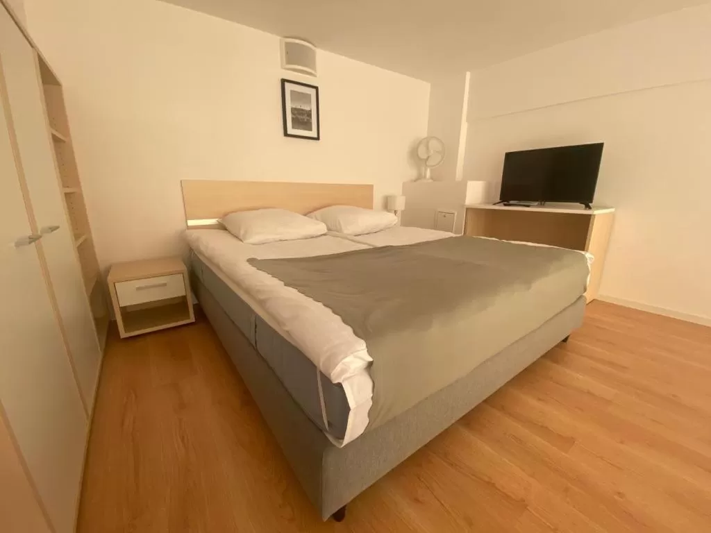 Bed in SleepWell Apartments